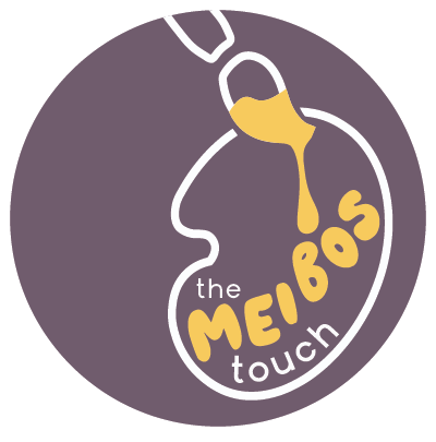 Logo for 'The Meigs Touch' featuring a stylized outline of a nose with a tube pouring a yellow liquid into a bottle, set against a purple background.