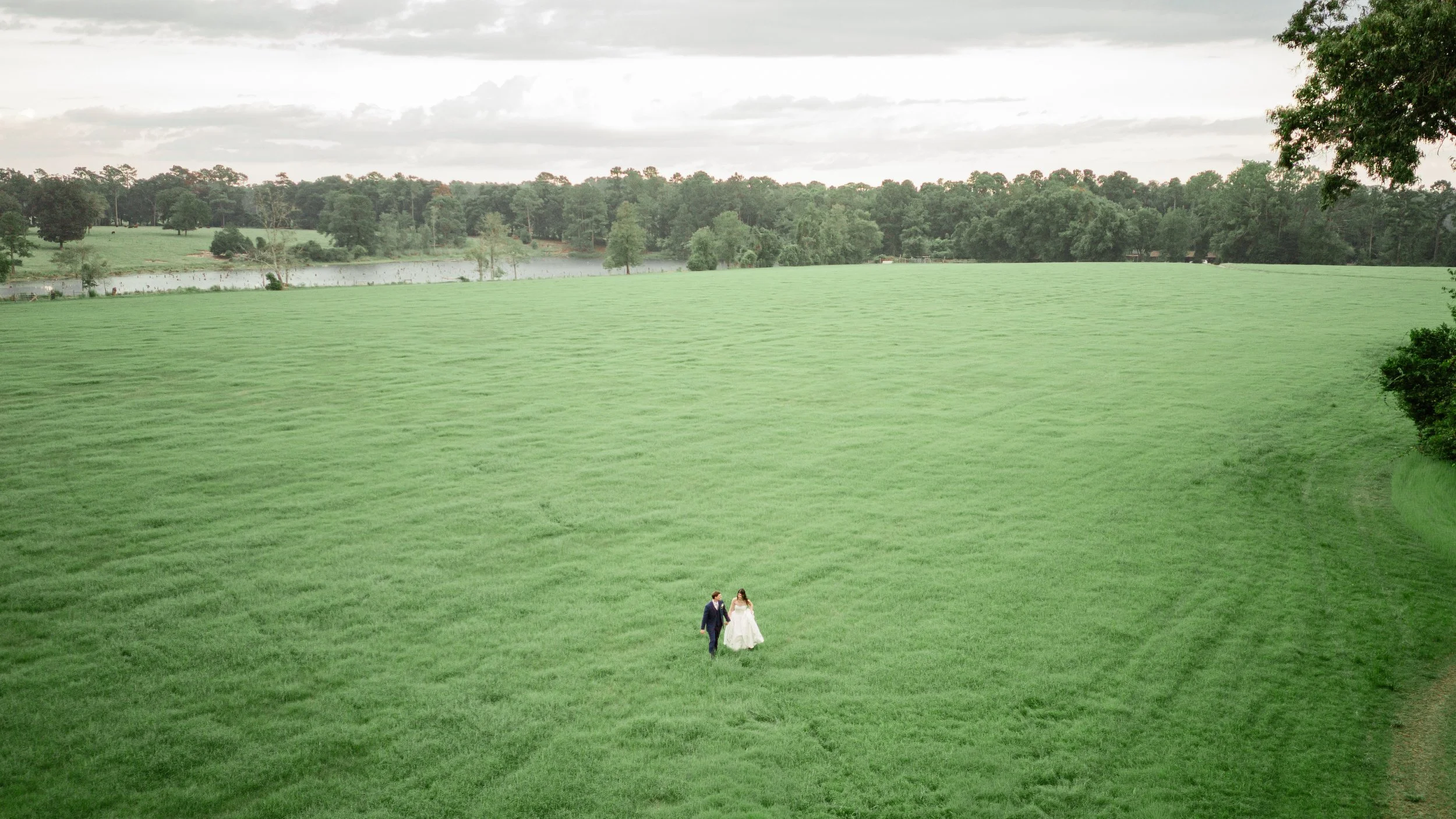 Bride and groom walking by a lake, Lowcountry bridal hair and makeup
