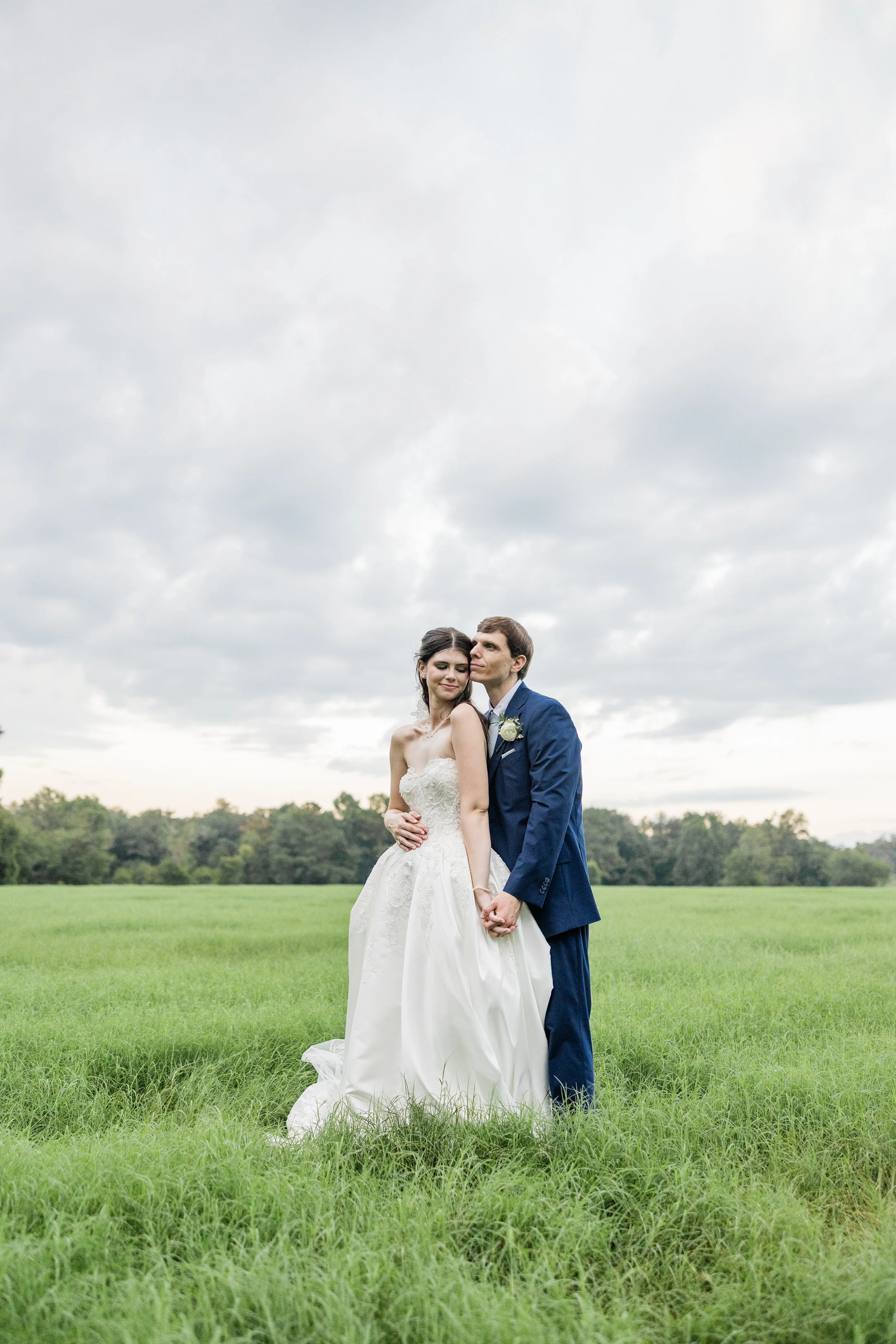 Wedding couple on grass, bride with bridal hair and makeup by Briar & Bleu
