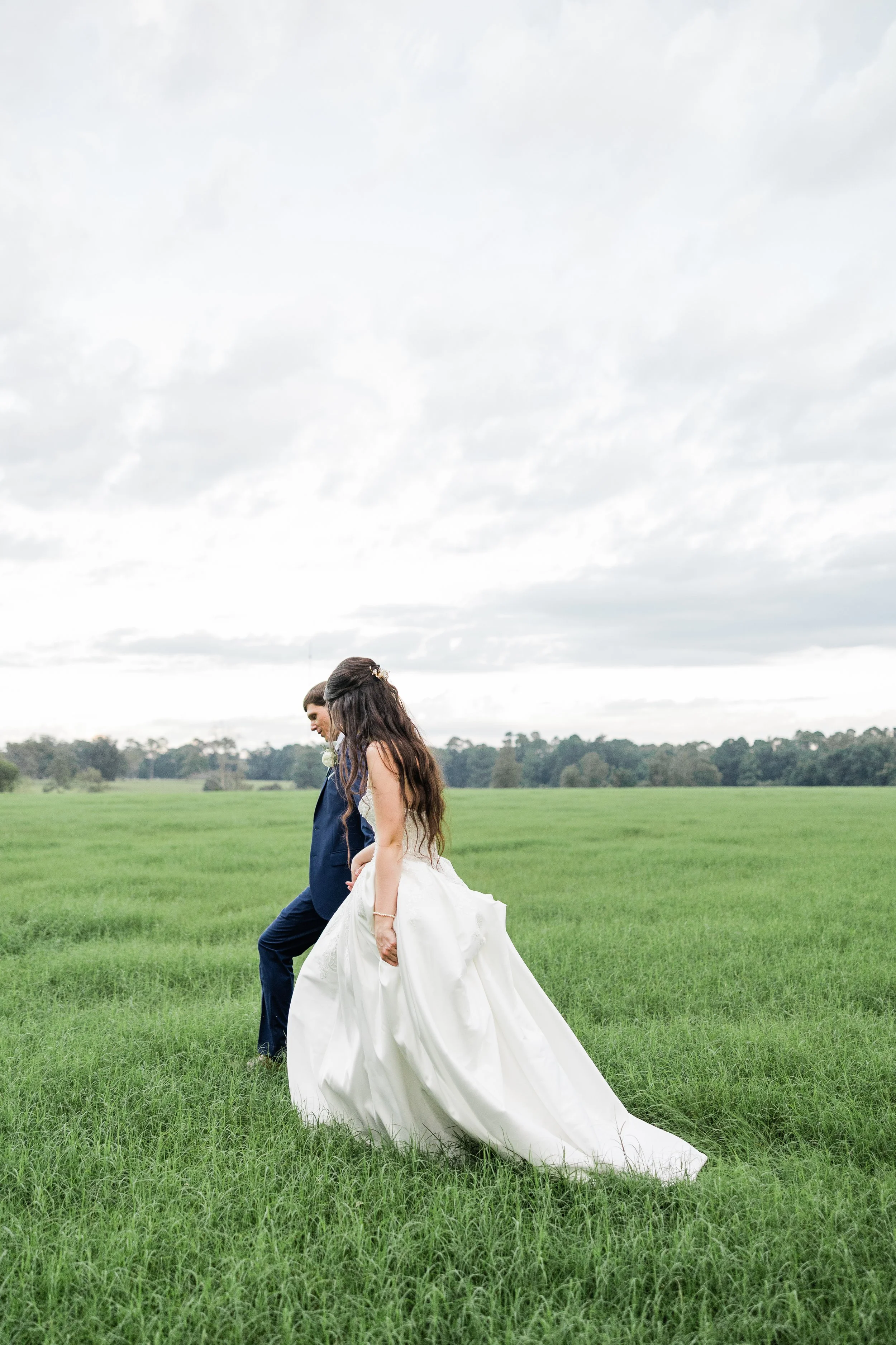 Bride and groom walking in a field, Lowcountry wedding by Briar & Bleu