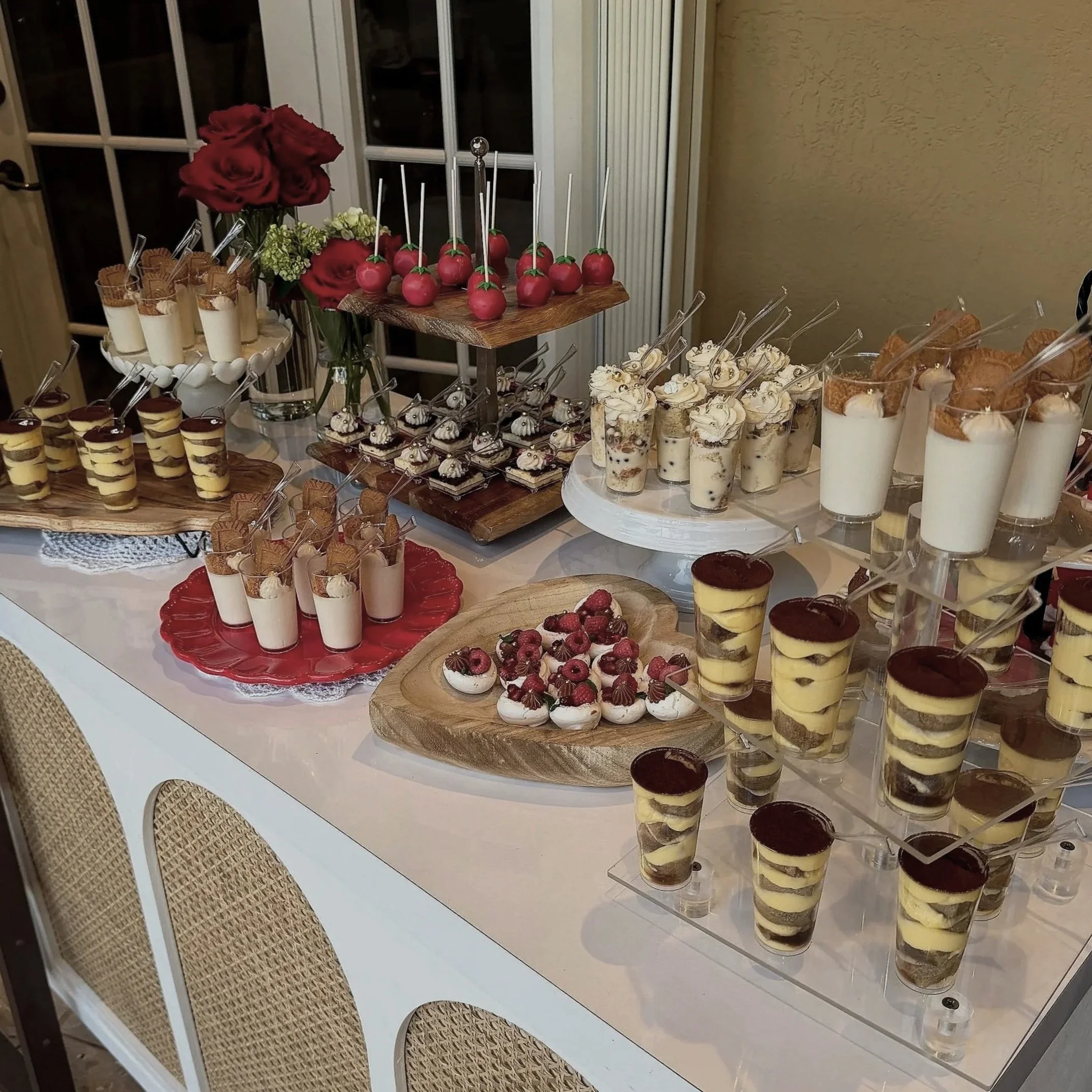 A luxury dessert table specially made for an engagement party, including Parfaits, mini Pavlovas, Tiramisus, Basque cheesecakes and cake pops.