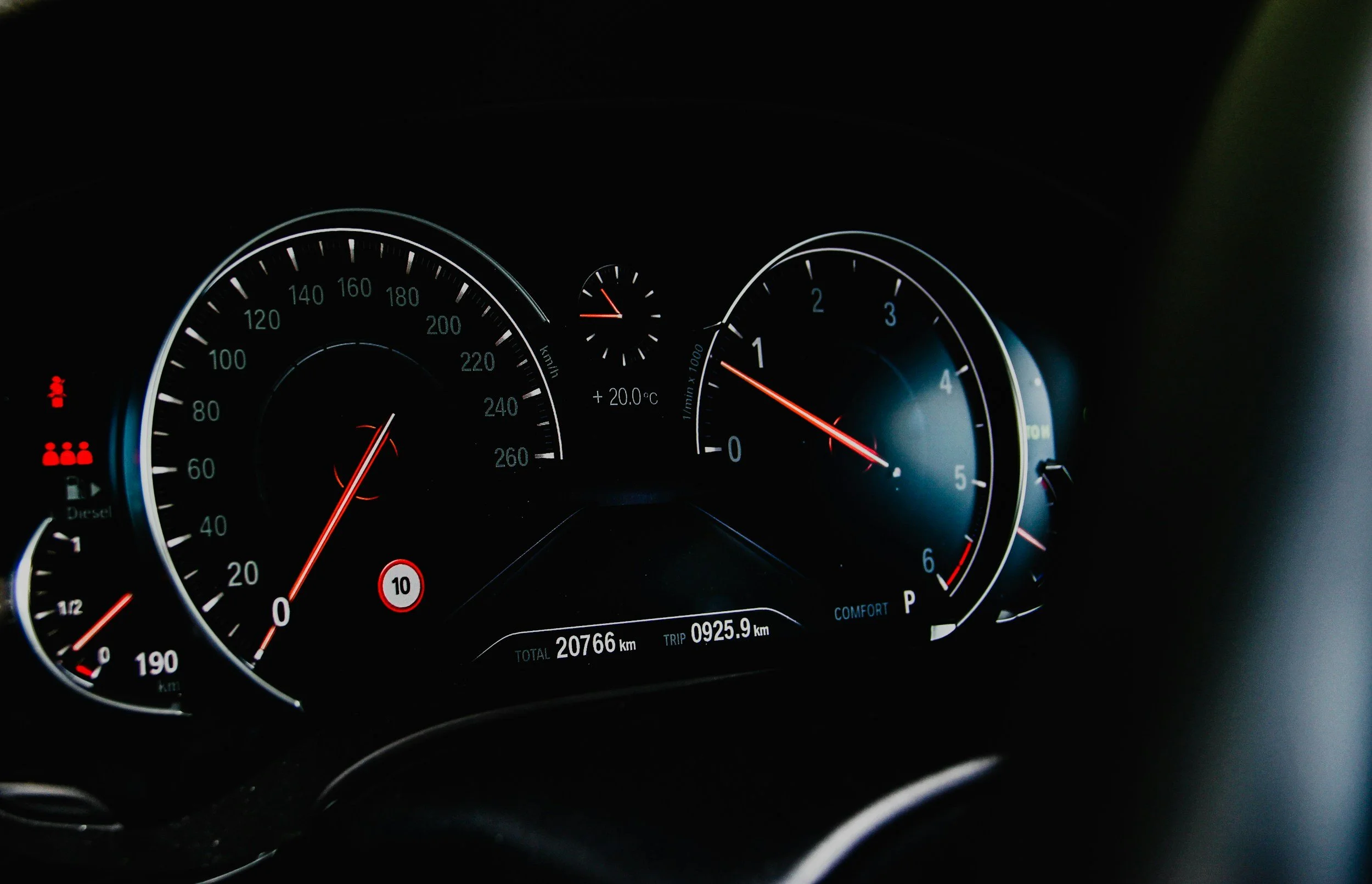 Car dashboard showing speedometer, tachometer, temperature, and fuel gauge with a total mileage of 20,766 kilometers.
