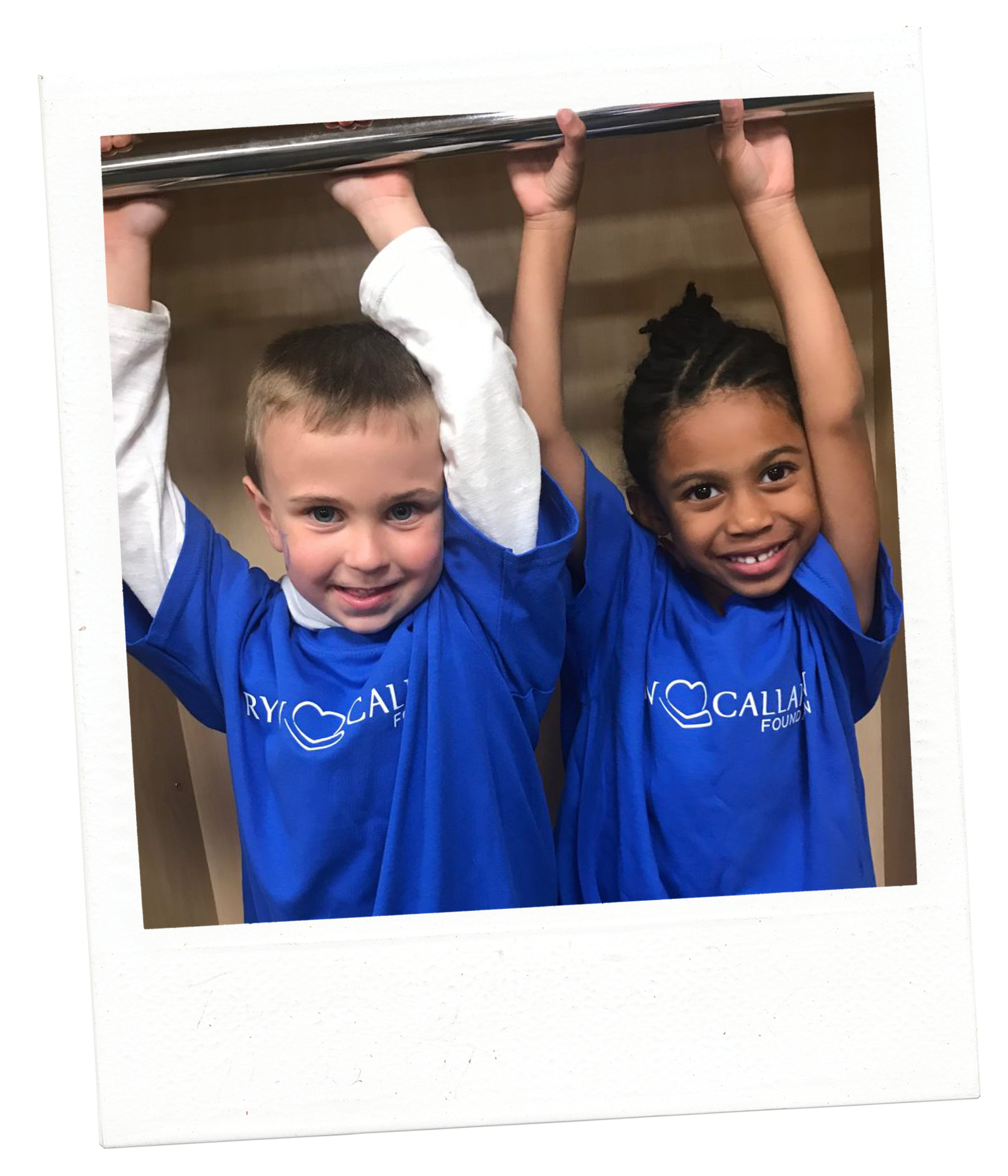 two children smiling with their arms up wearing blue Ryan Callahan Foundation tshirts