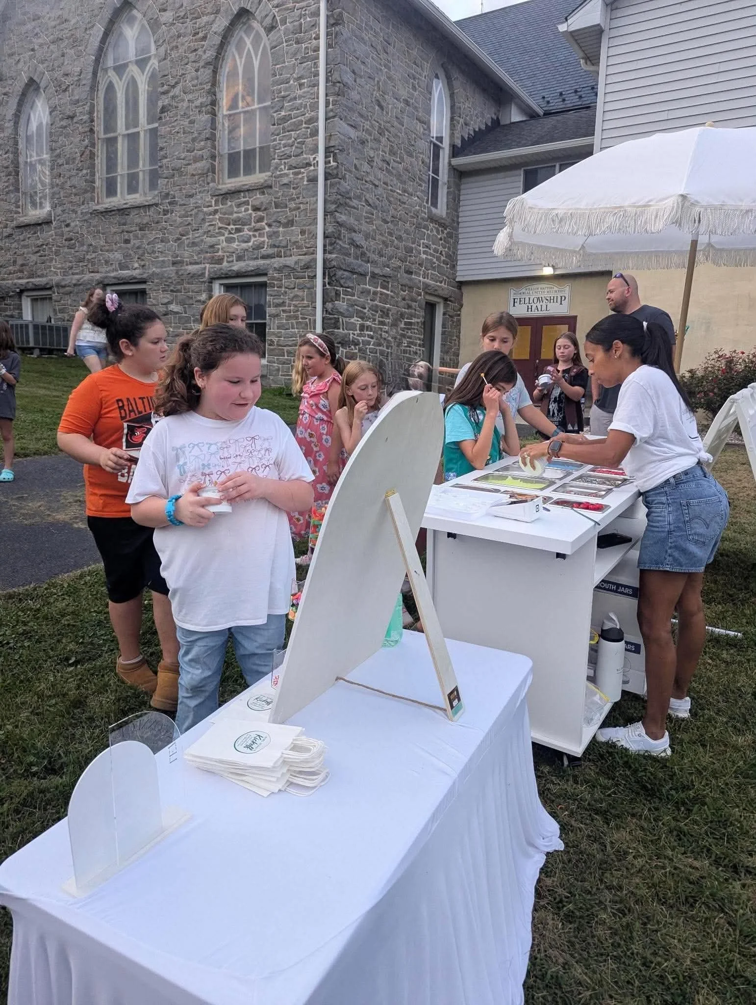 Children enjoying a slime activity at an outdoor event