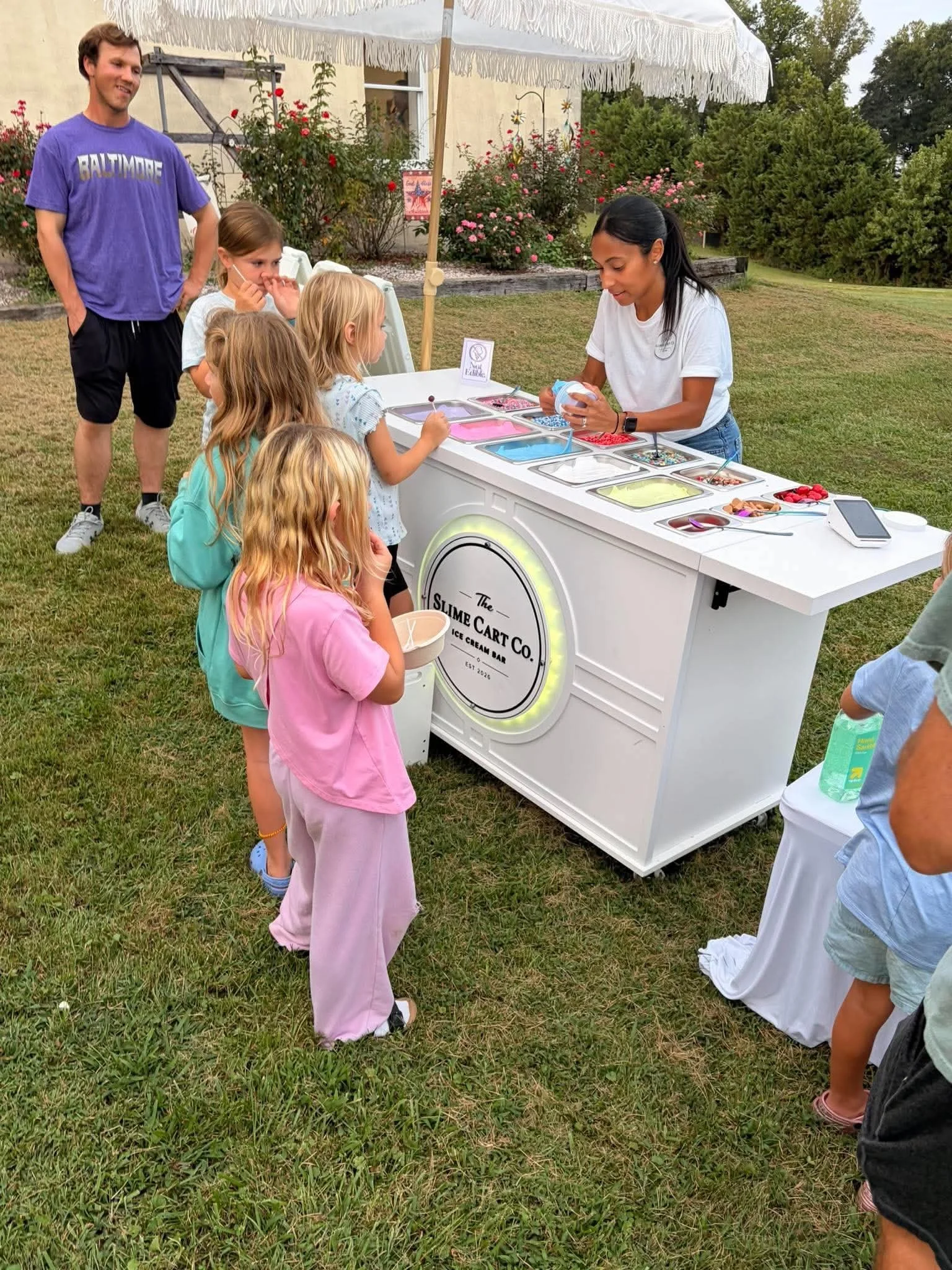 Children enjoying a slime activity at an outdoor event.