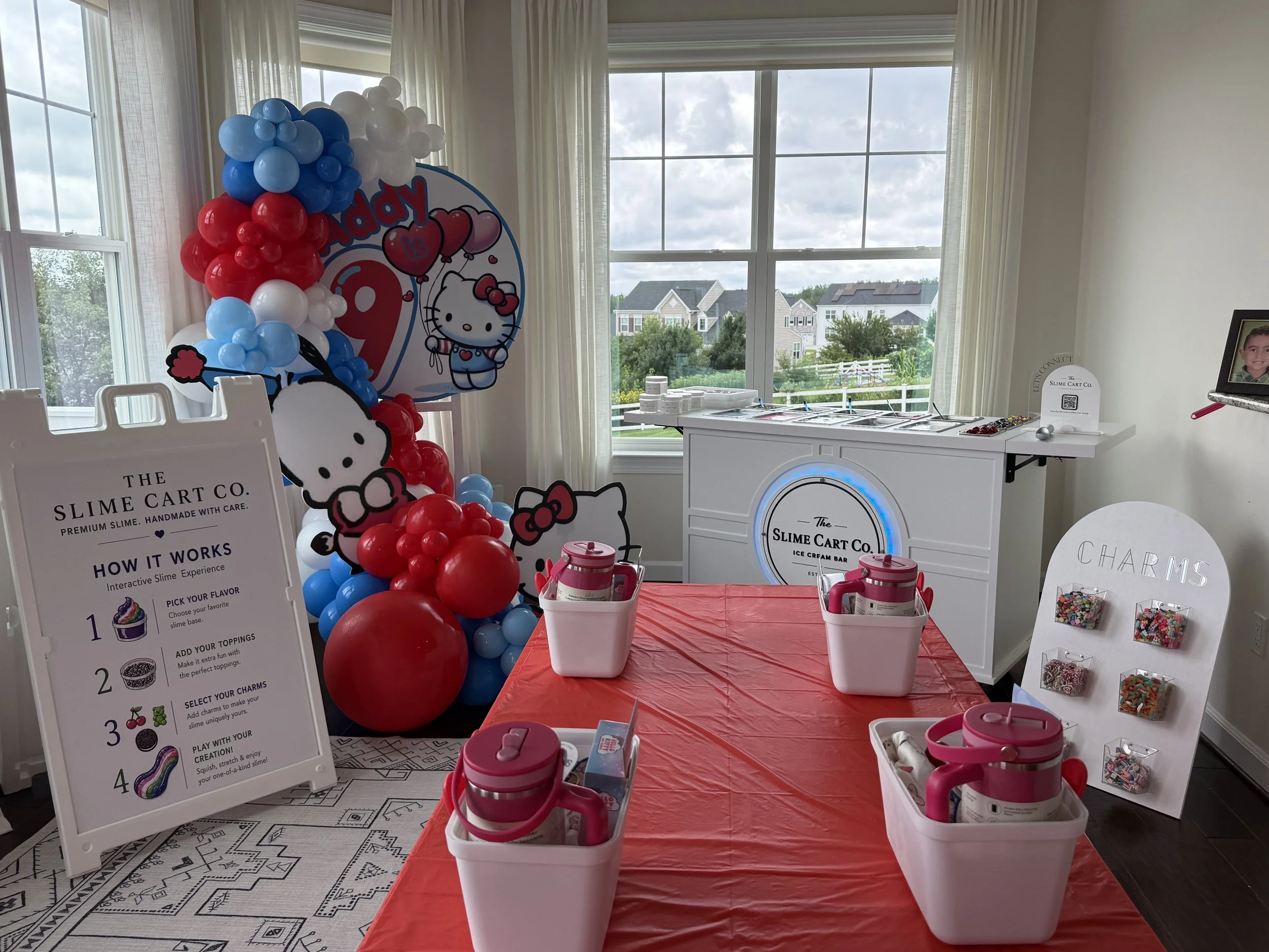 The Slime Cart Co. birthday party setup with colorful balloons and slime stations.