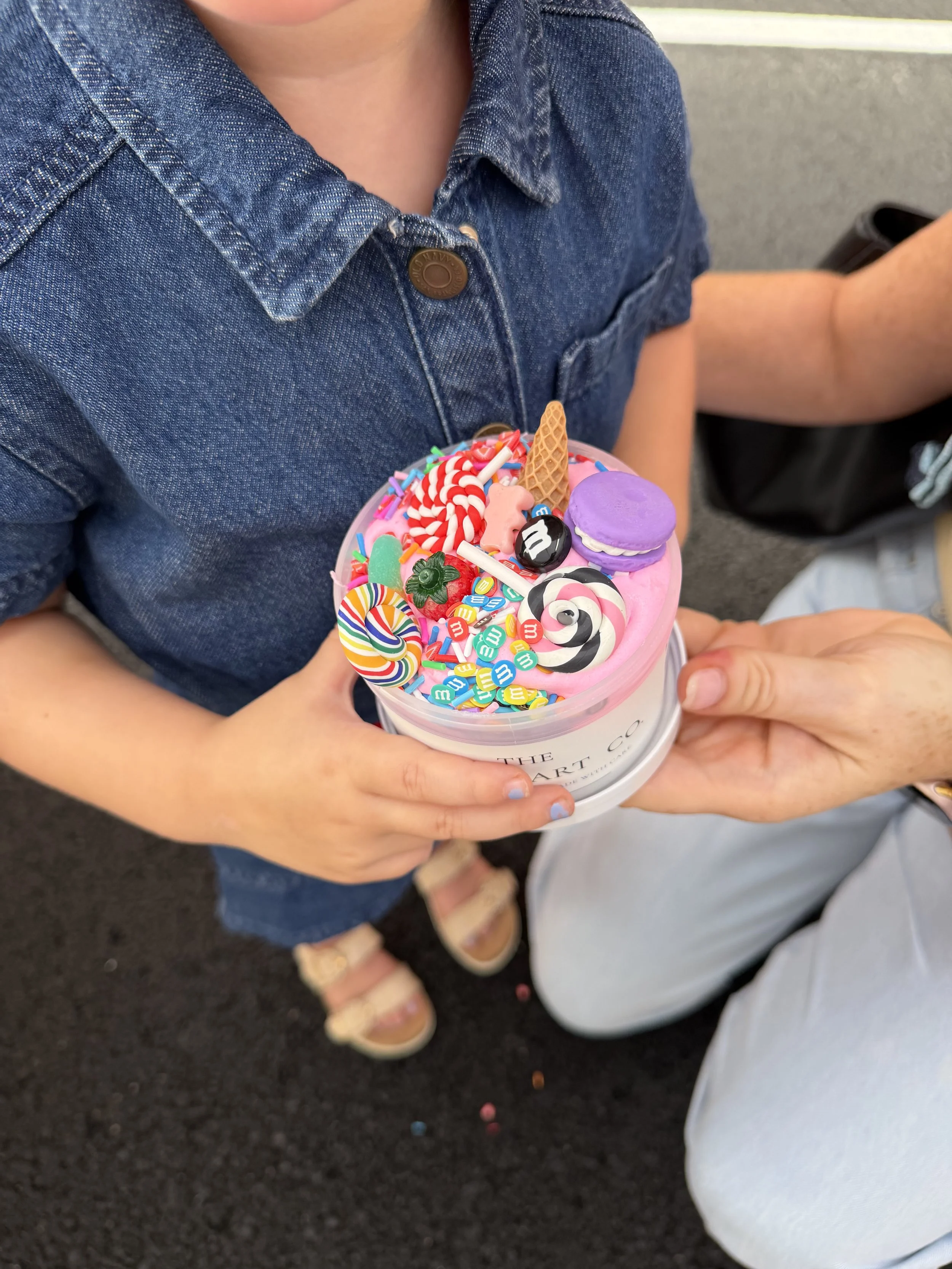 A child holding a custom slime creation.
