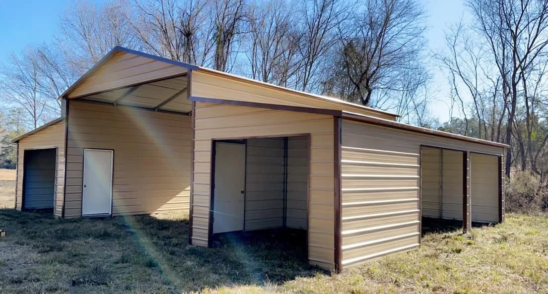 A beige metal storage shed with multiple bays in an outdoor setting with trees in the background.