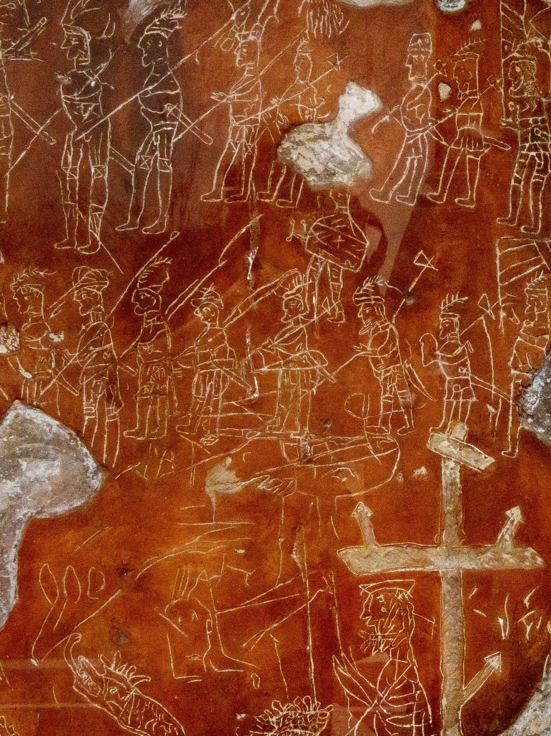 Ancient cave painting depicting various human figures, animals, and possibly mythological characters, all outlined in white on a reddish-brown background.