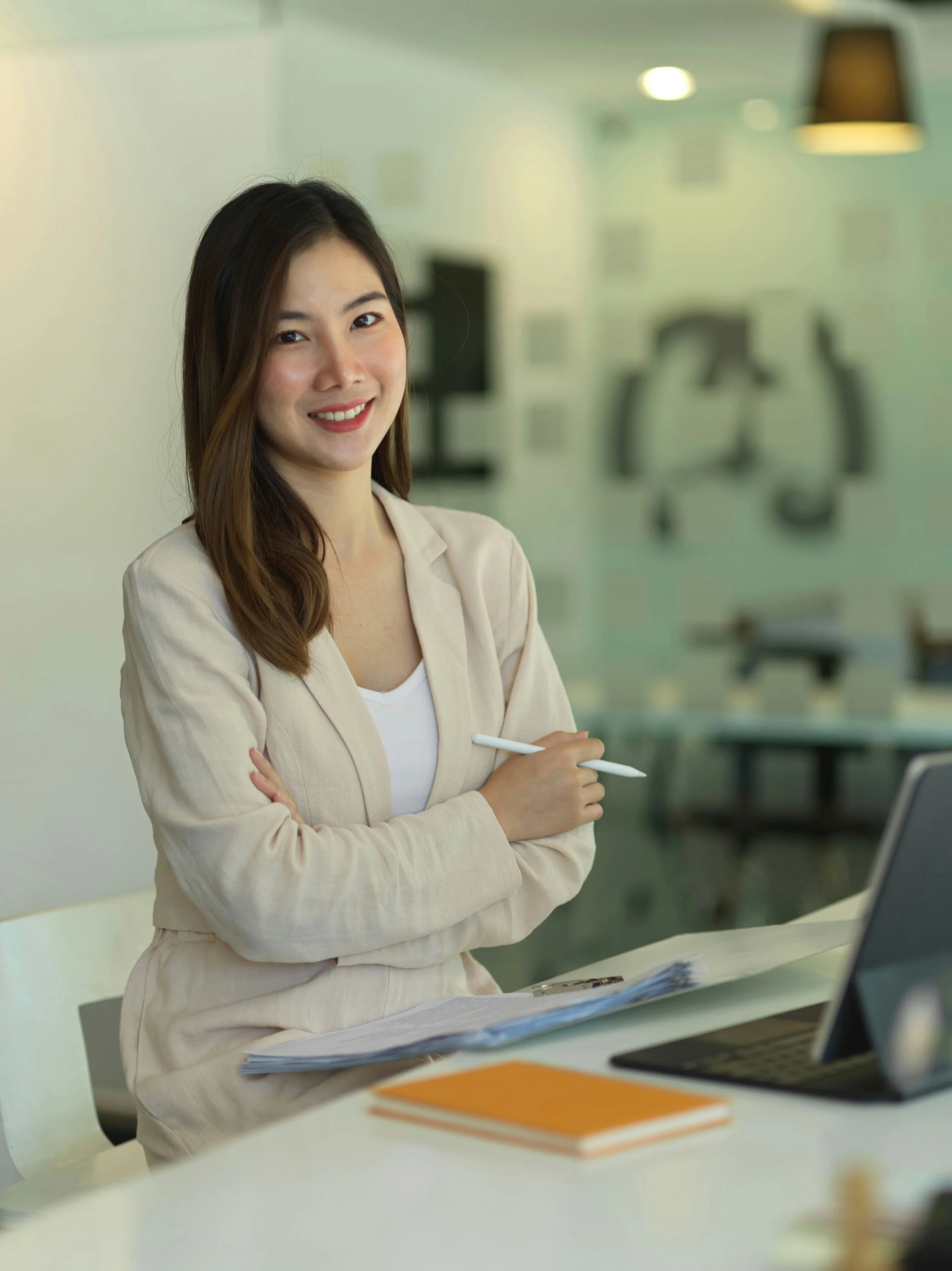 A young woman standing in a professional office smiling