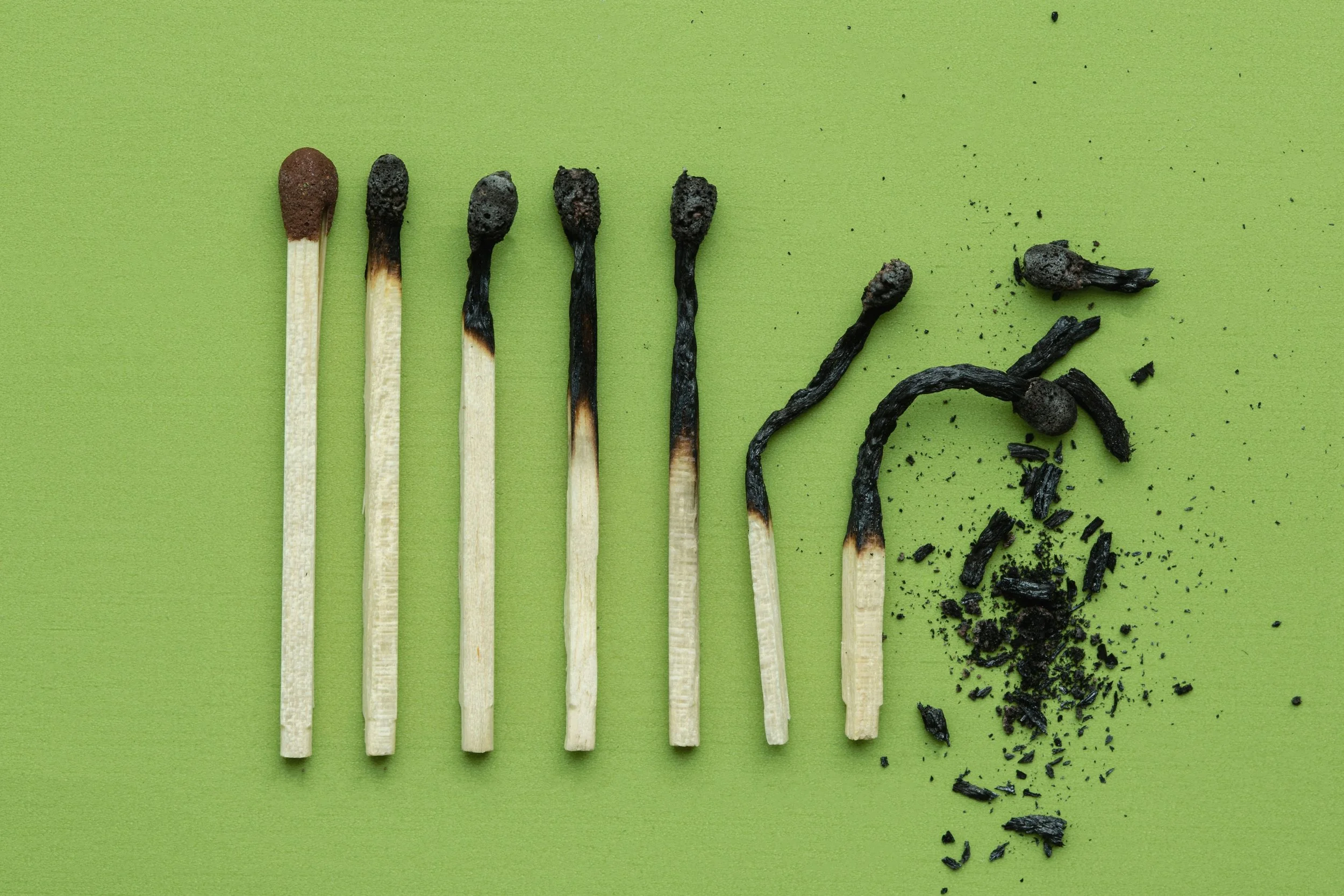 A picture of a series of successively depleted matchsticks, symbolizing the depleting effect of burnout