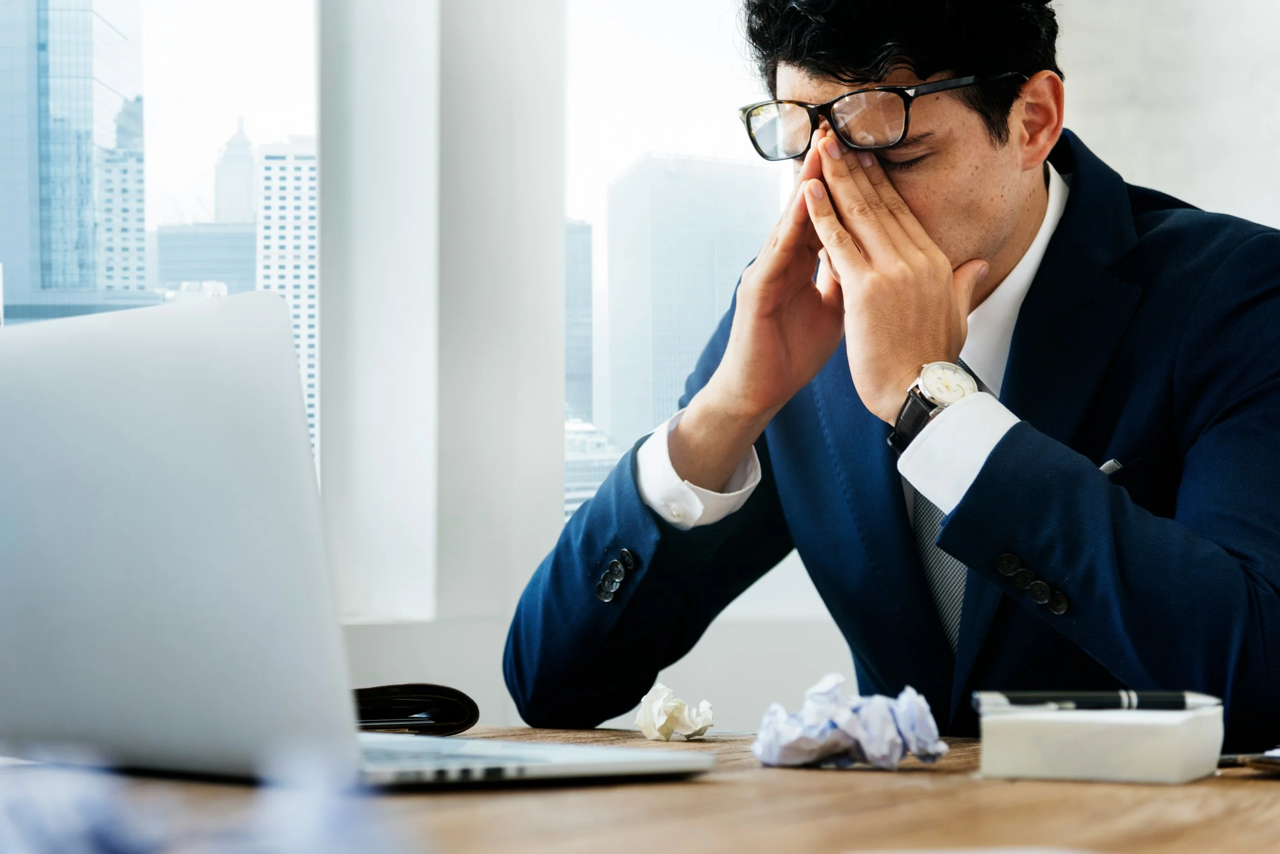 Lawyer with his face in his hands symbolizing lawyer burnout