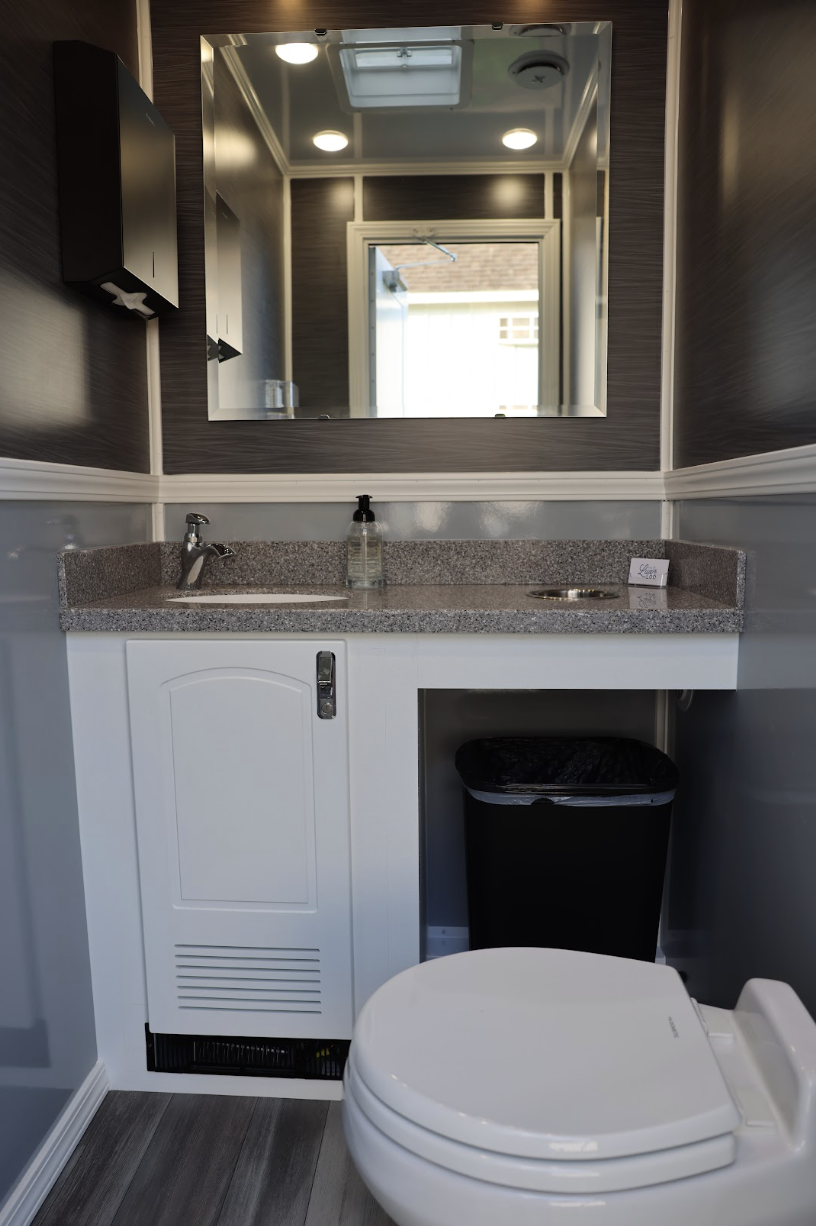 Modern restroom suite with LED lighting and running water