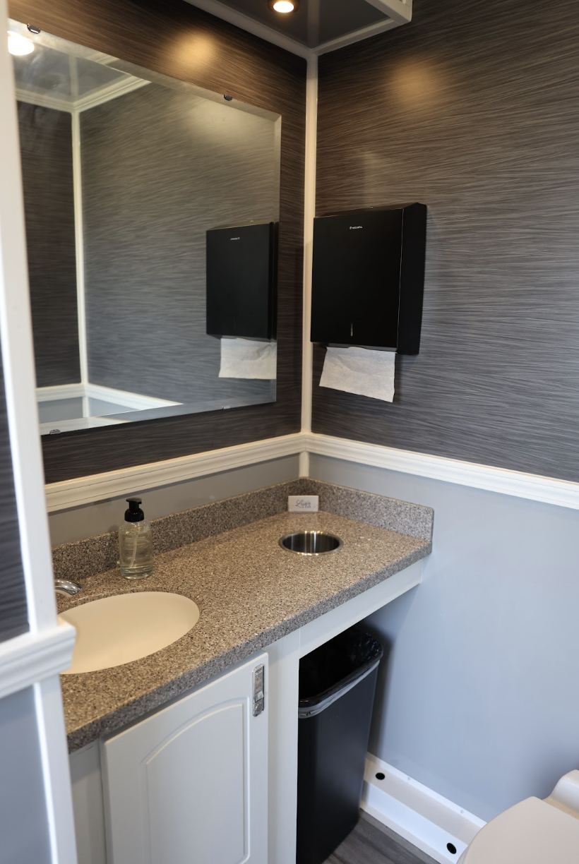 Private restroom suite inside a luxury restroom trailer