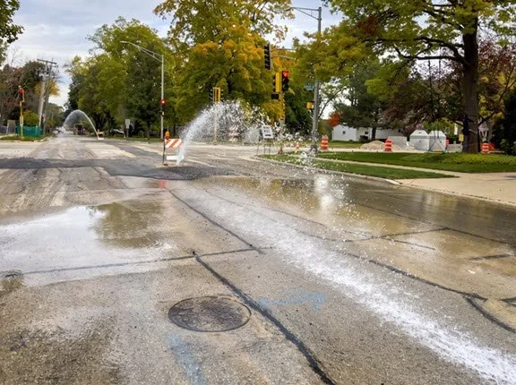 Water main break flooding a city street