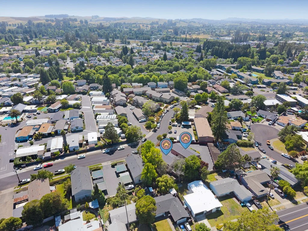 Aerial view of a residential neighborhood with houses, trees, and streets in a suburban area.