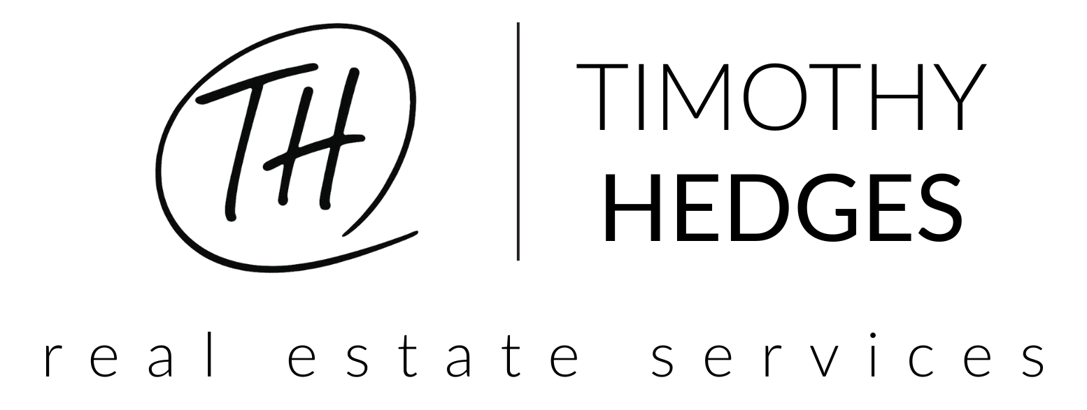 Close-up of a black t-shirt featuring the printed text 'The H' in a stylized font on the front.