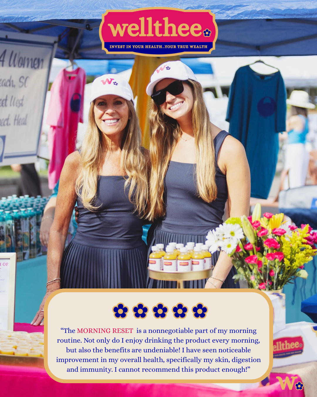 Two smiling women at a Wellthee booth with colorful flowers and health products, promoting a health supplement called The Morning Reset at an outdoor market.