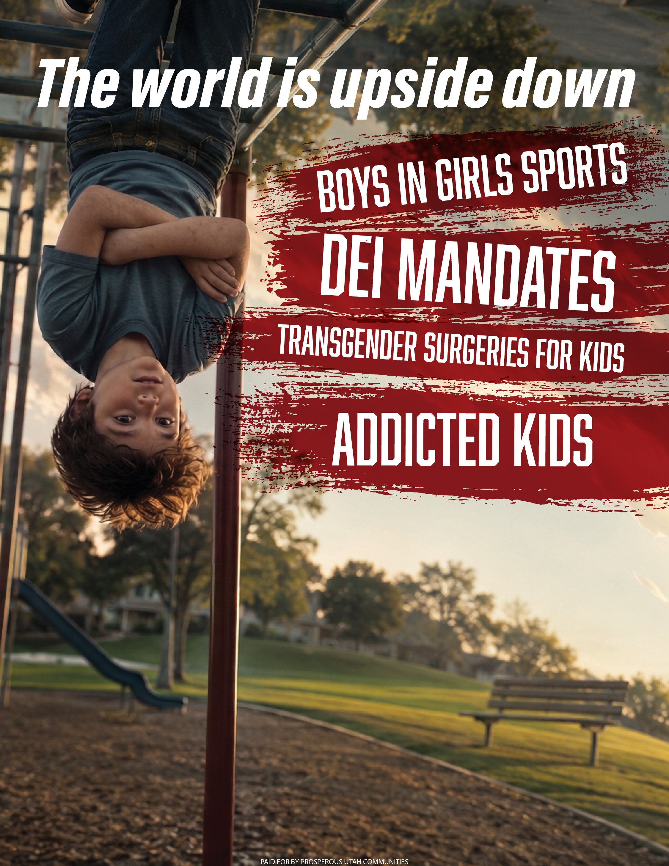 Child hanging upside down on playground equipment at sunset in a park with benches and trees in the background.