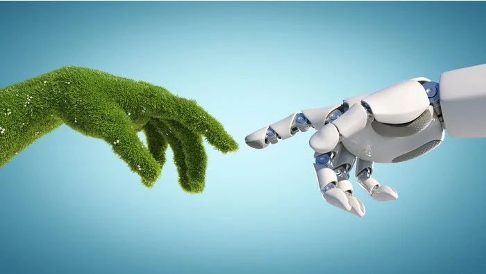 A digital image of a human hand made of grass reaching out to a robotic hand made of metal and plastic, symbolizing technology and nature connection.