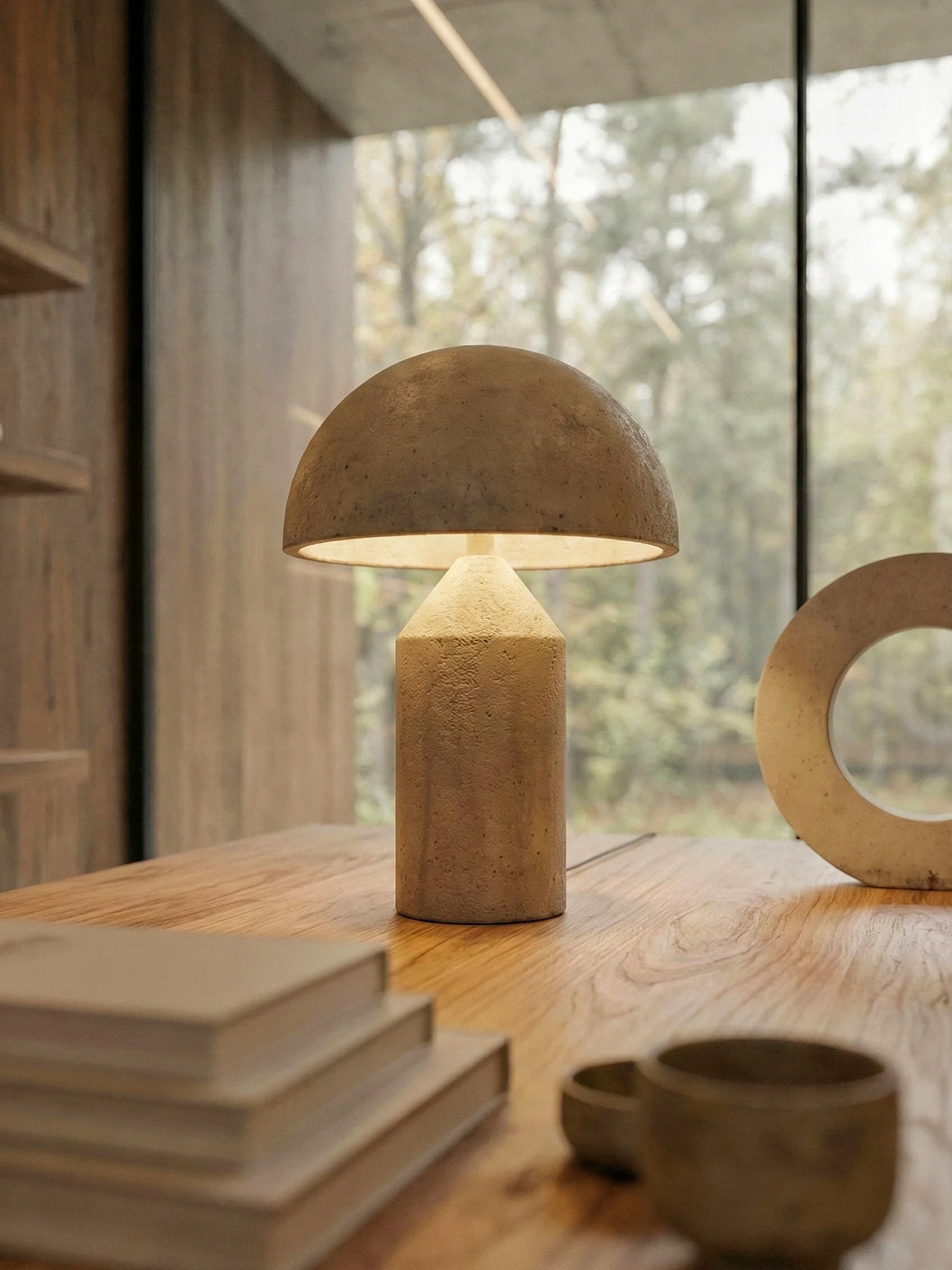 Kunststof decoratieve objecten op een houten tafel, met een achtergrond van een raam met uitzicht op bomen.