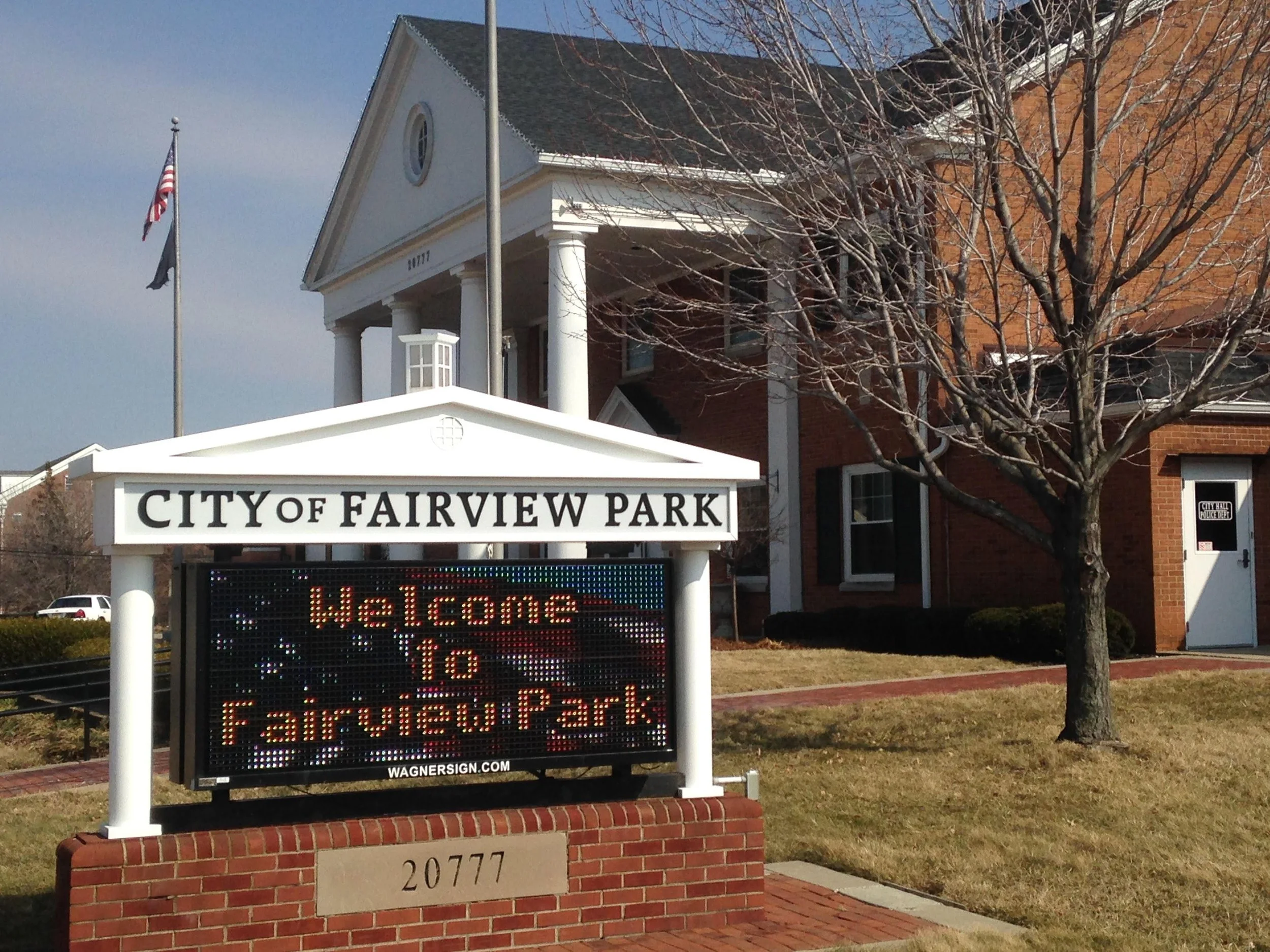 Sign for the City of Fairview Park with electronic display welcoming visitors.