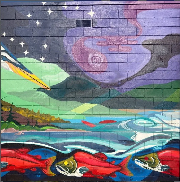 Colorful mural of a river landscape with fish, mountains, and a swirling sky with stars and a large purple cloud.