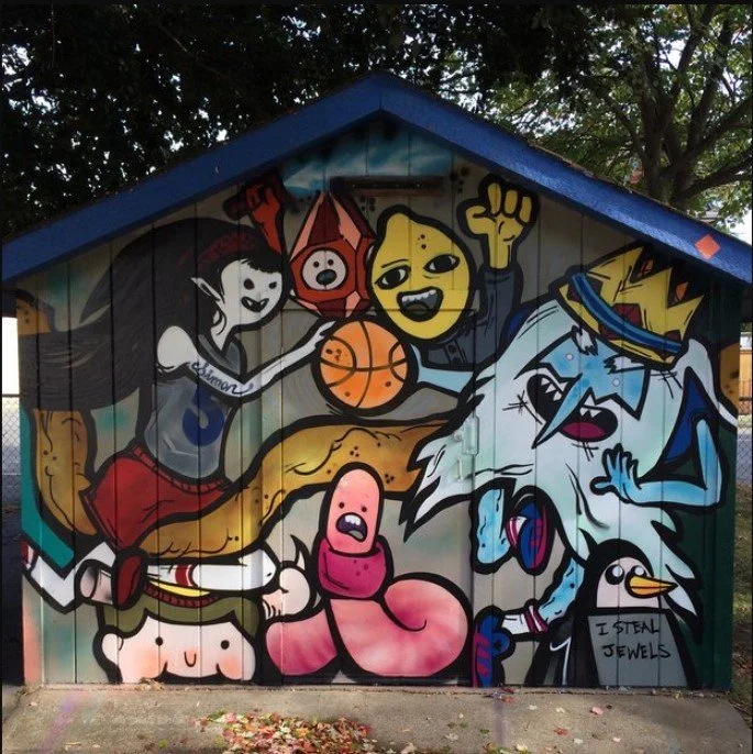 Colorful mural of animated characters playing sports and making expressive faces, with a small penguin and a sign saying 'I steal jewels'.