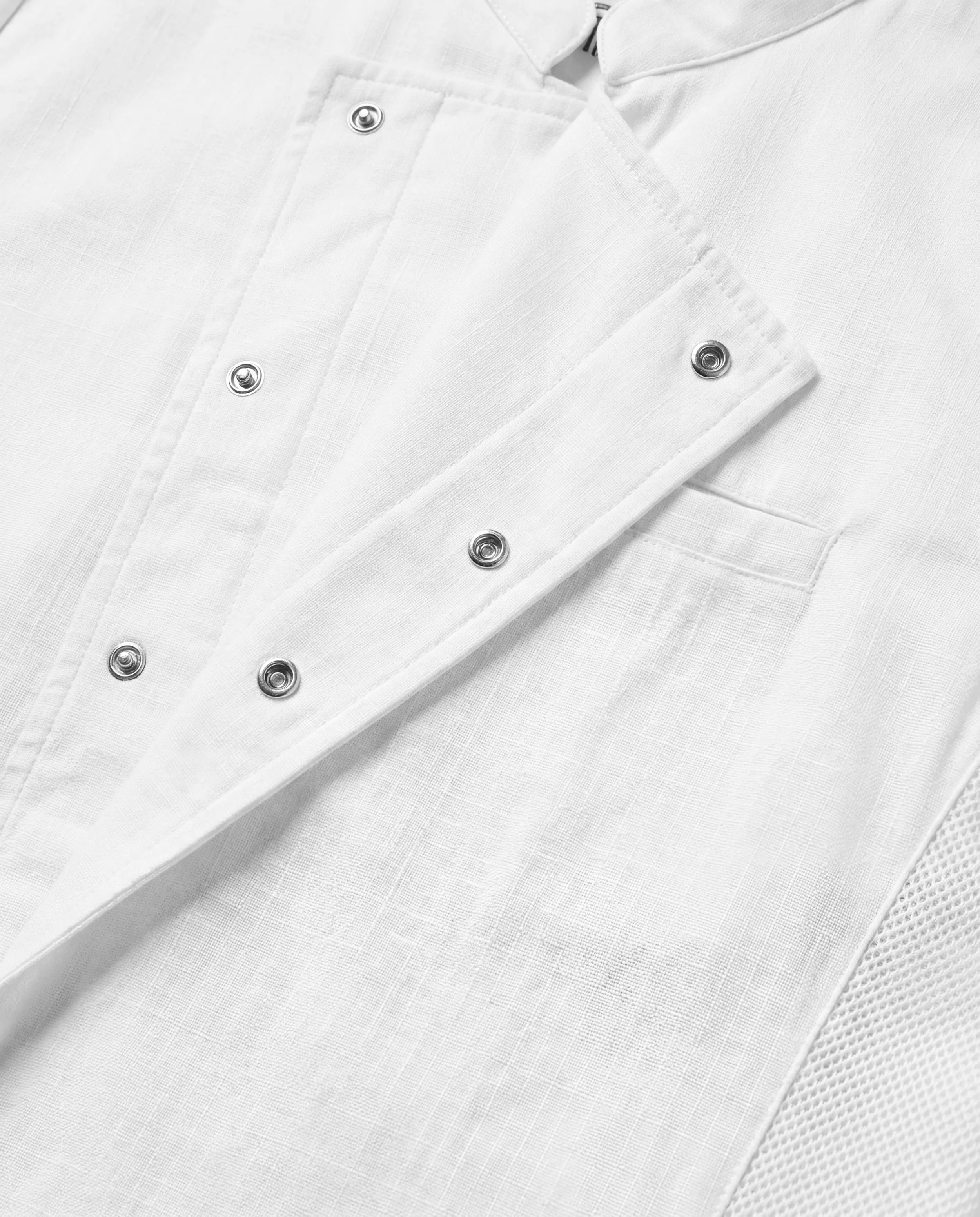 Close-up of the ChefShield™ Pro Chef Jacket front closure, showing the concealed snap fastening, structured fabric and refined construction details.