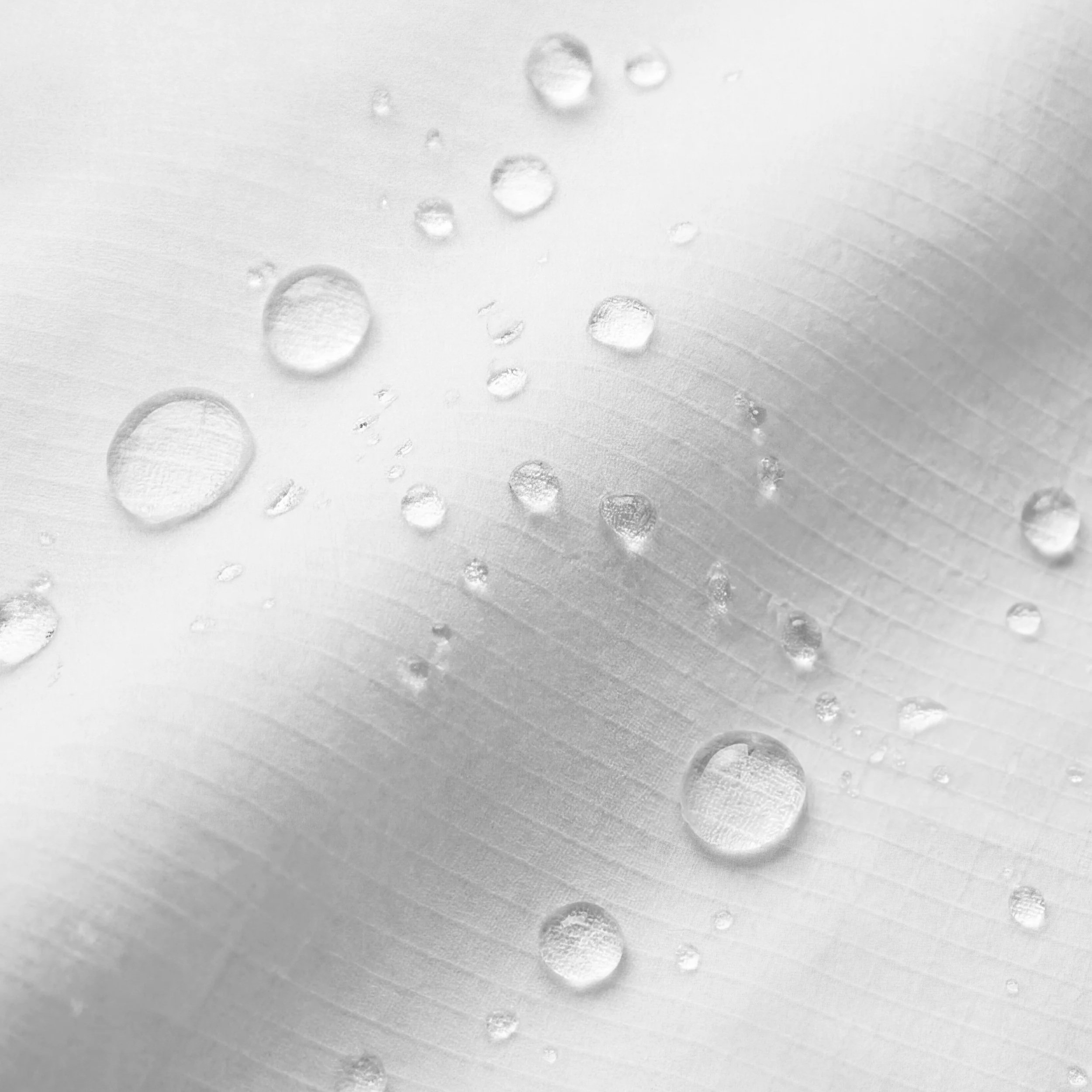 Close-up of water droplets on a smooth surface.