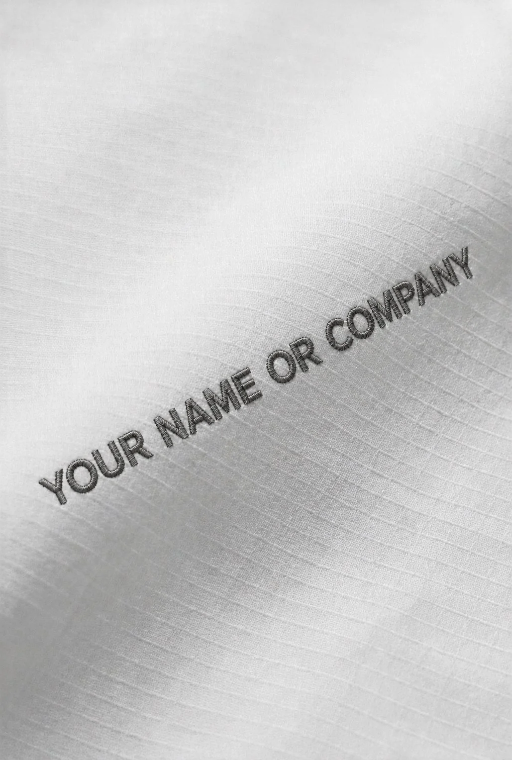 Close-up of ChefShield™ Pro Chef Jacket featuring personalised text embroidery on the structured chefwear fabric.