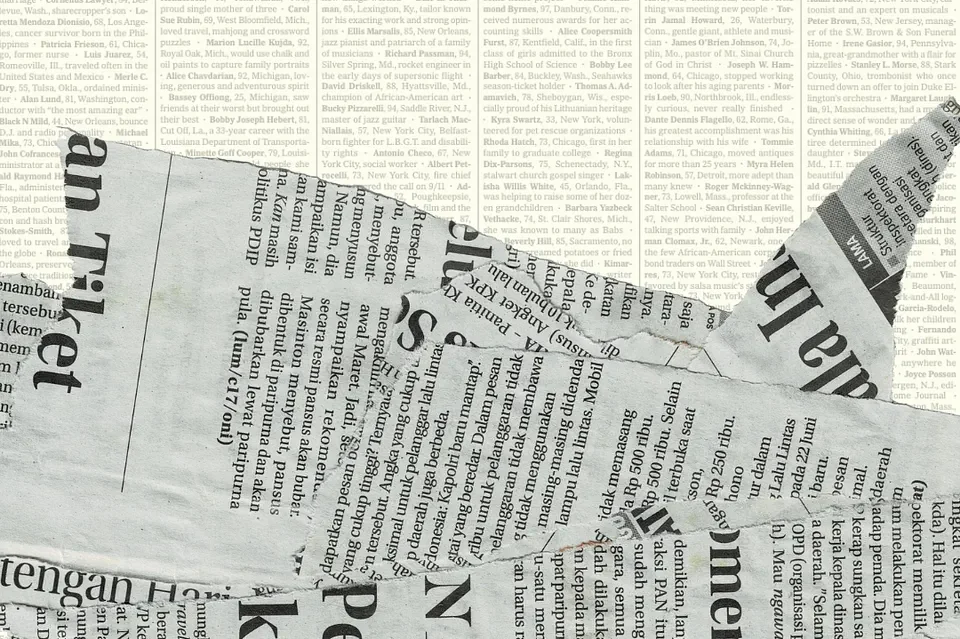 Collage of torn newspaper clippings with overlapping pieces, showing text in English and Indonesian, featuring headlines, articles, and advertisements.