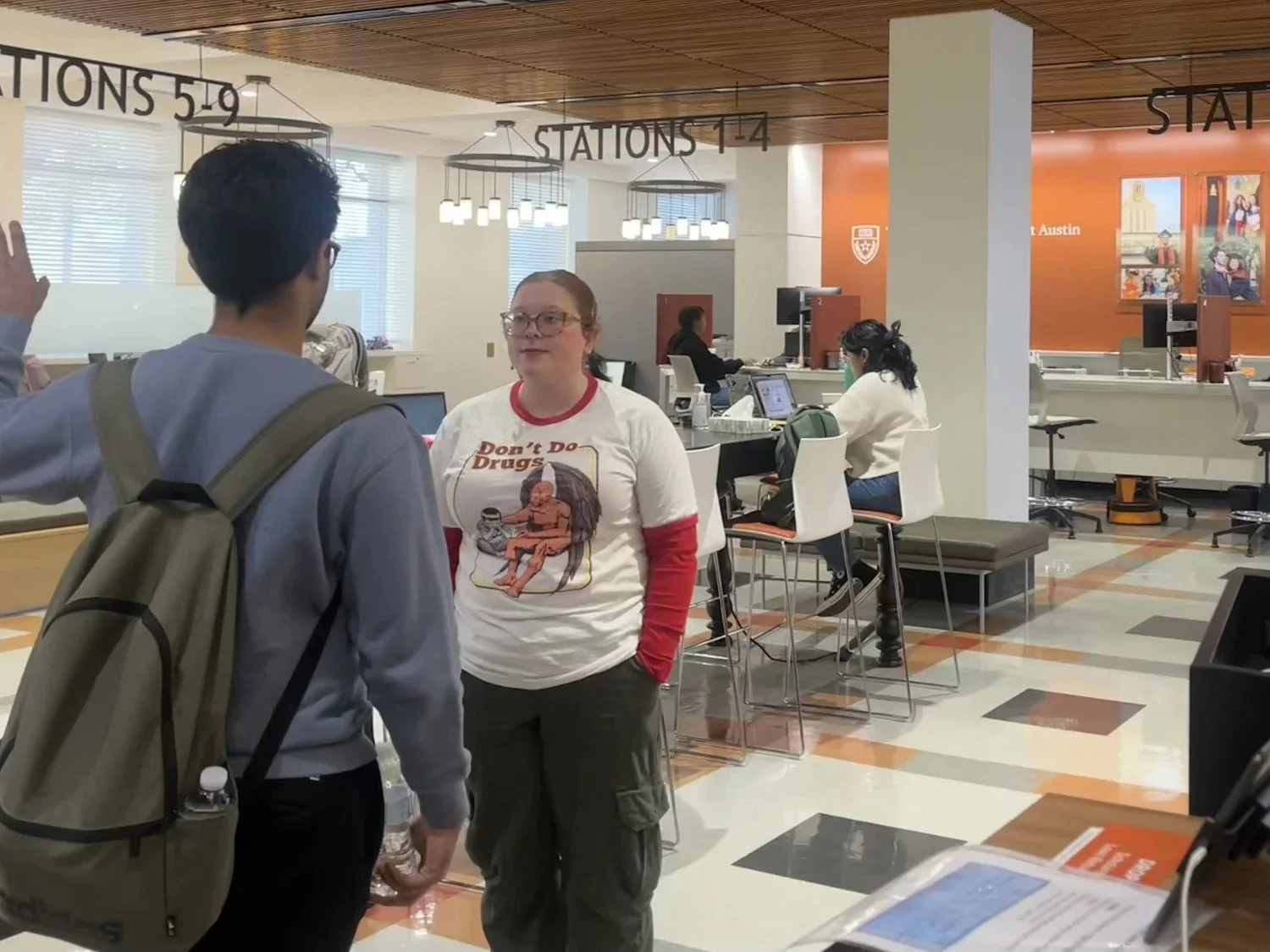  Nicky Alexander, nursing junior and student associate at UT’s Texas One Stop, assists a student at the Texas One Stop office on Feb. 15, 2024, in Austin, Texas. The Texas One Stop office opened on June 14, 2022, and offers students a space to take c