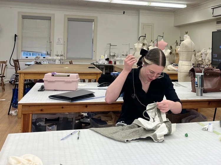  Textiles and apparel senior Emily Wagner hand sews a collar into a shirt she is making for her collection which was inspired by epic tales and stories she grew up with on April 10, 2024. (Photo credit: Sonali Menon) 