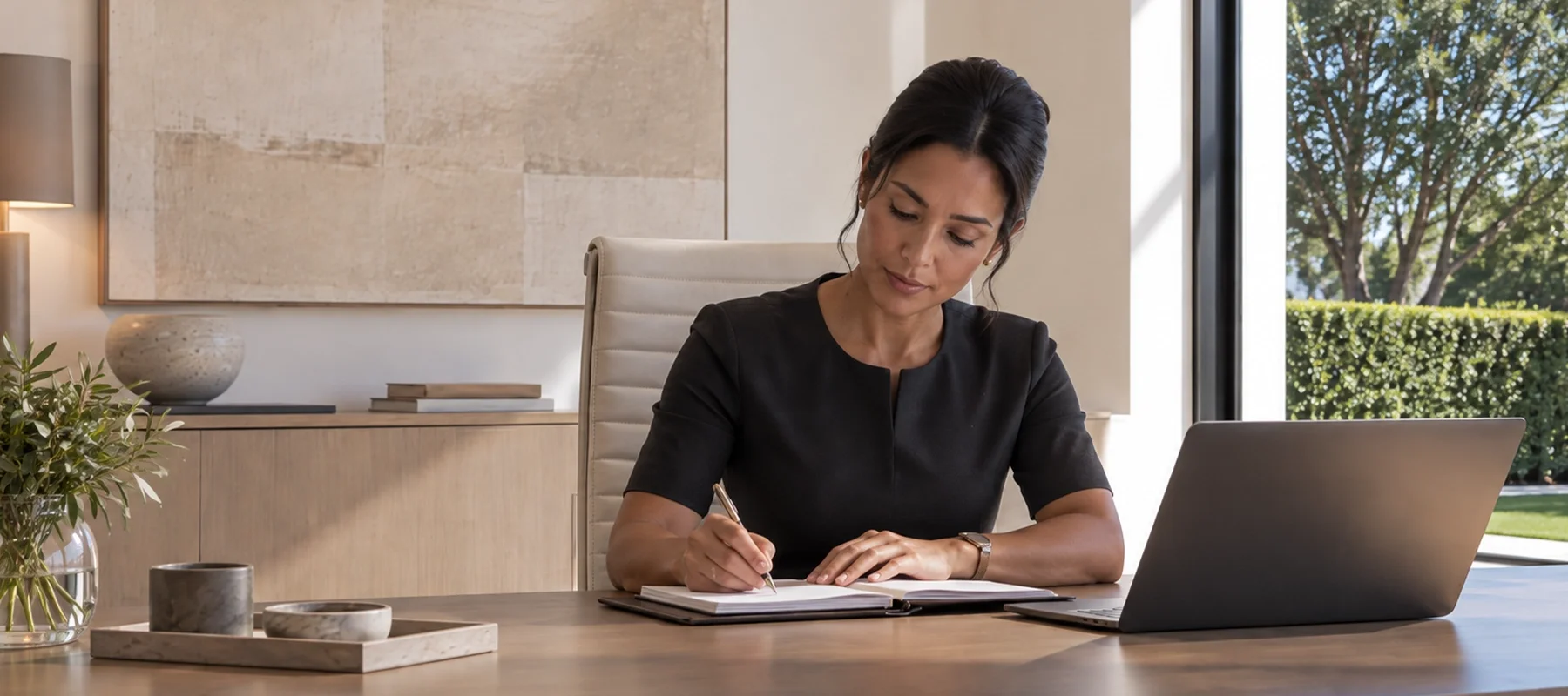 House manager in her office making notes in her diary