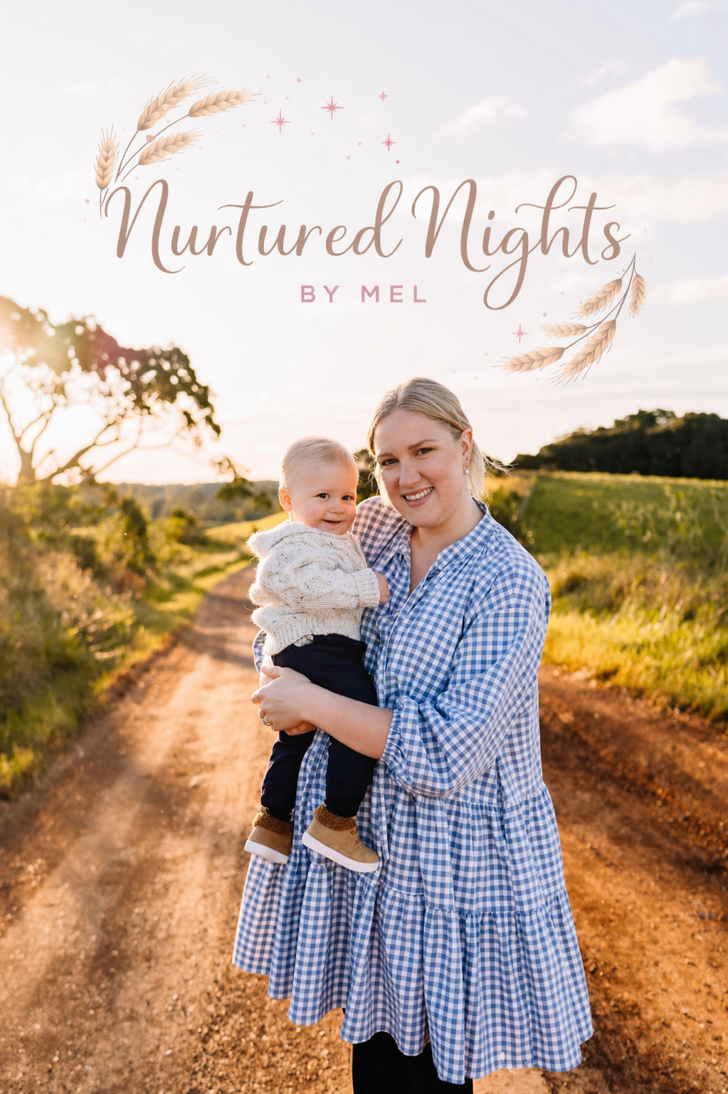 A woman holding a young child on a rural dirt path during sunset with trees and grassy fields in the background.