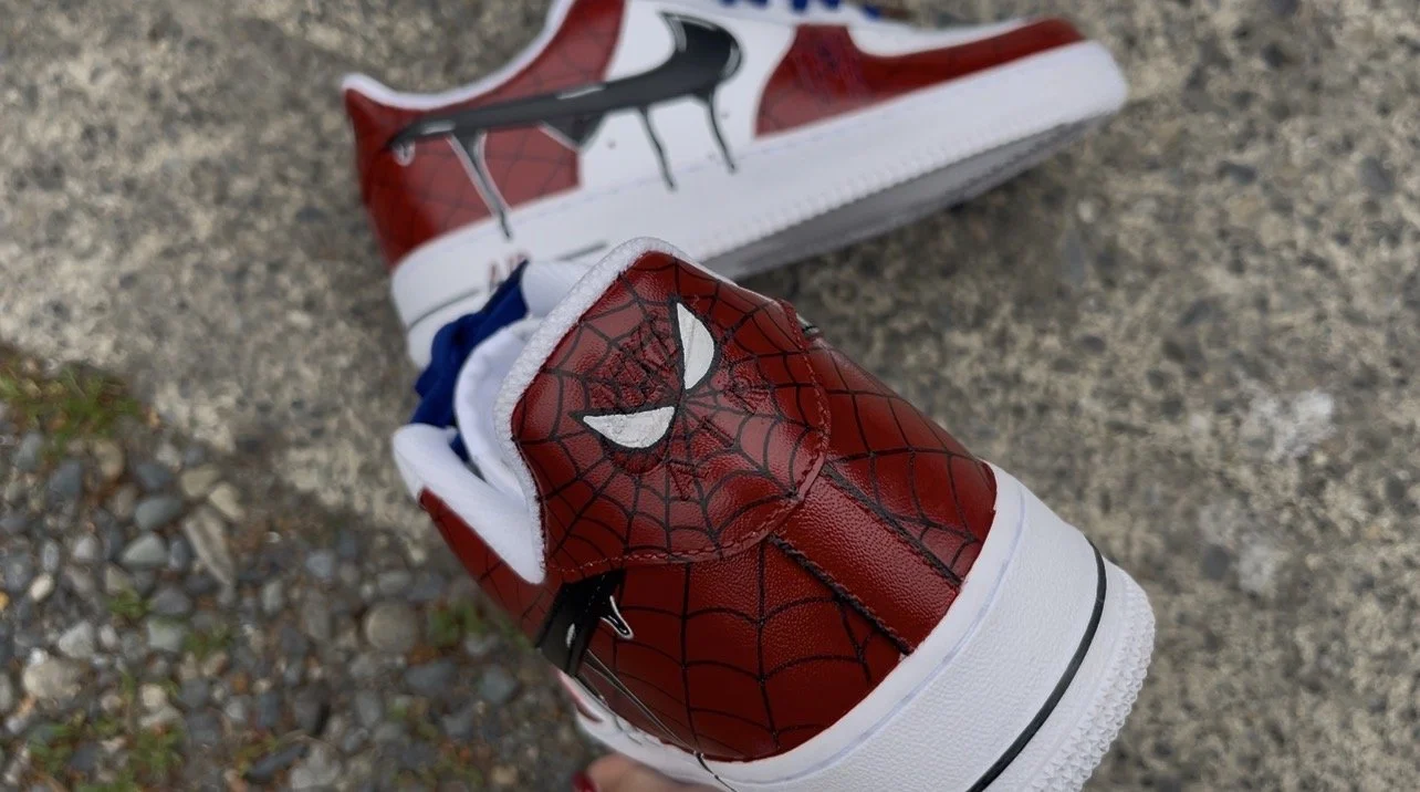Heel detail featuring hand-painted Spider-Man eyes and webbing on custom Air Force 1 sneakers.