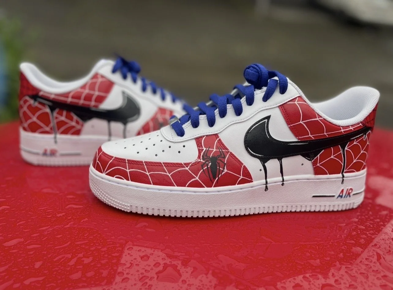 Side view of Spider-Man custom Nike Air Force 1 with red web pattern and blue laces