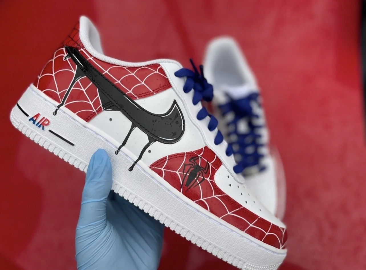 Close-up of Spider-Man custom Air Force 1 featuring hand-painted web detailing and black spider emblem