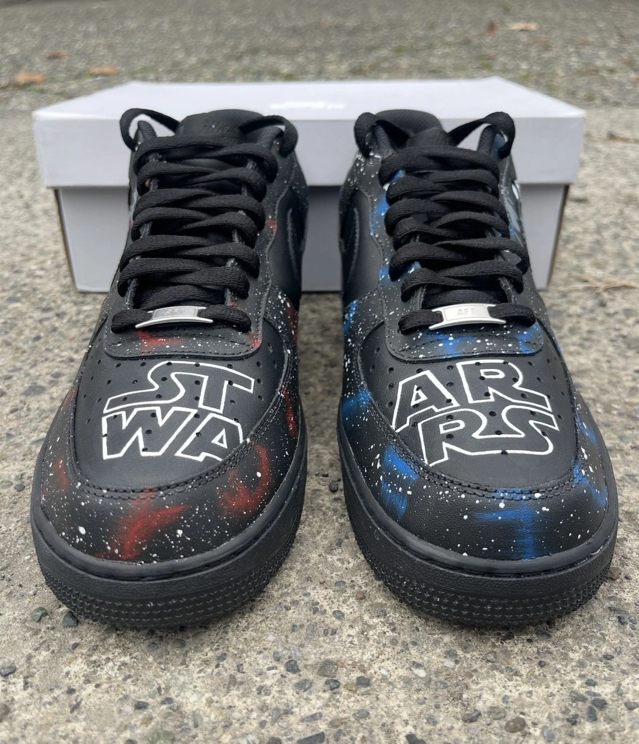 Hand-painted Star Wars logo across the toe boxes of custom black Nike Air Force 1 sneakers