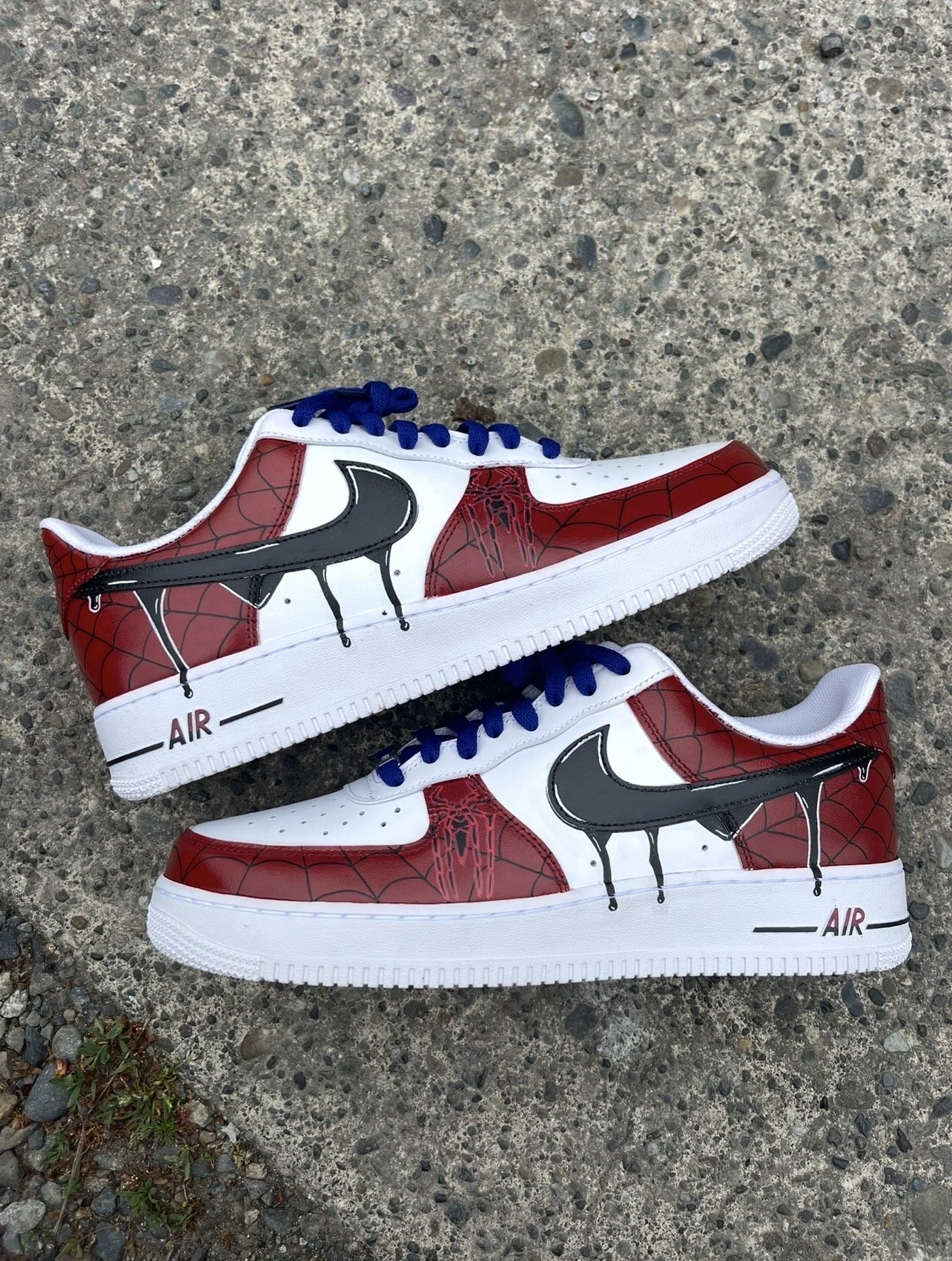 Custom Andrew Garfield Spider-Man Air Force 1 sneakers featuring hand-painted webbing, blue laces, and dripping black swooshes.