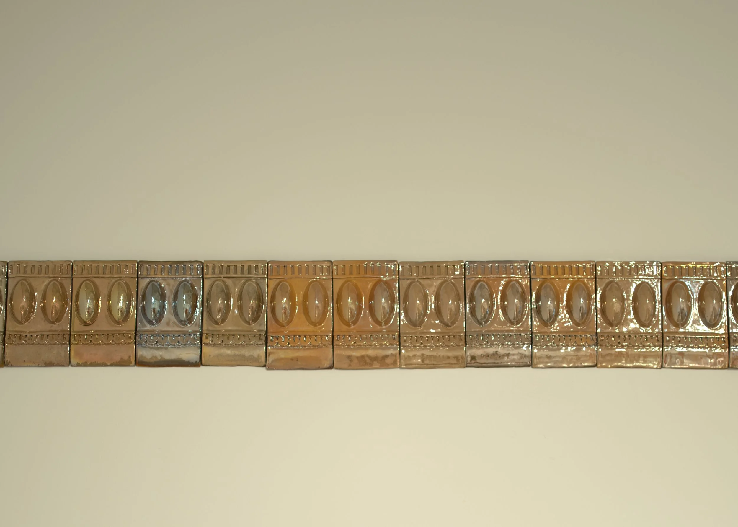 Tiles I Ceramic, In-glaze lustre I 22 x 12 x 7 cm each (part of 32.5 ft long tile installation) I 2023