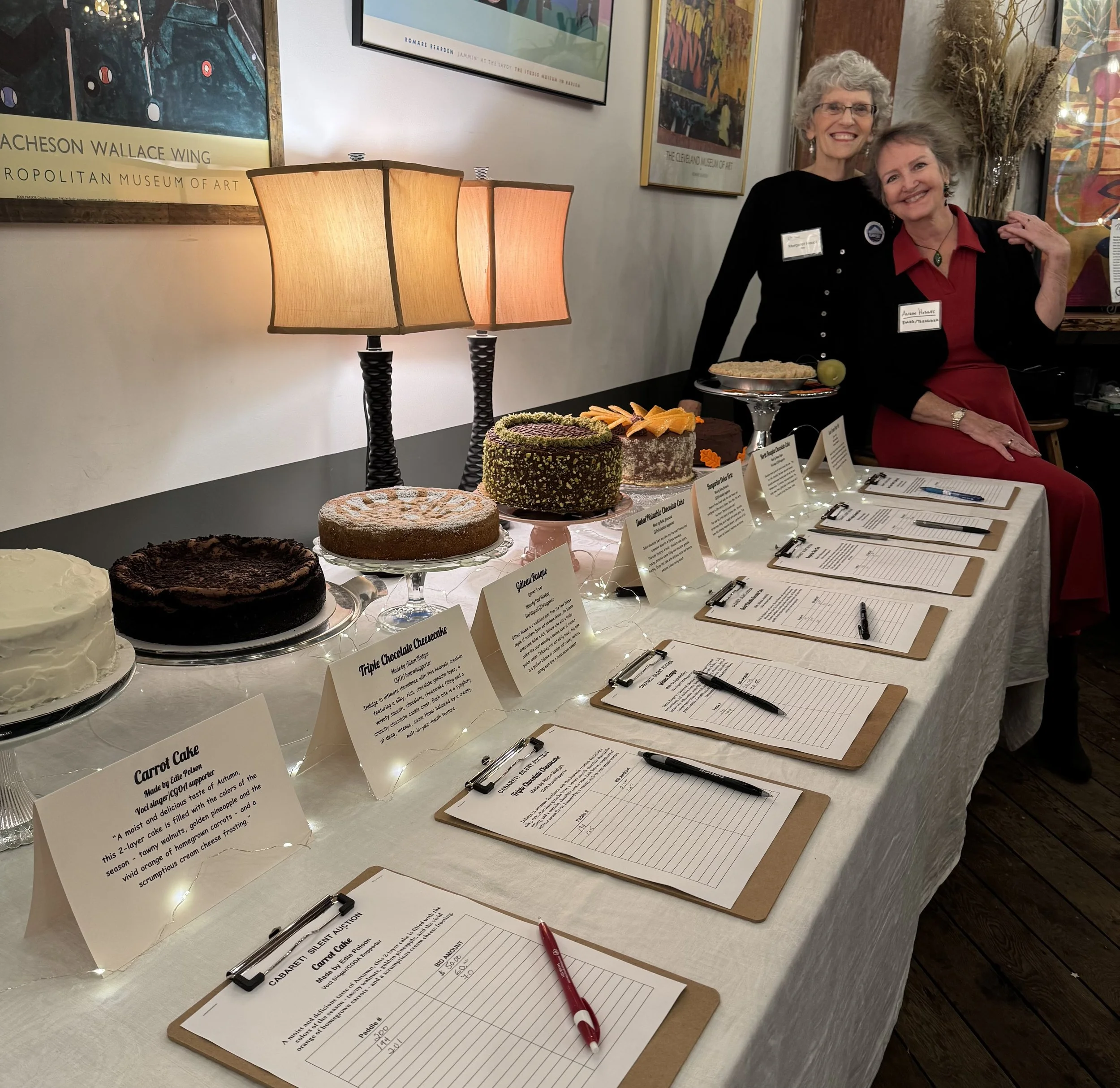 CGOA Fundraiser with Margaret and Alison volunteering during the cake silent auction