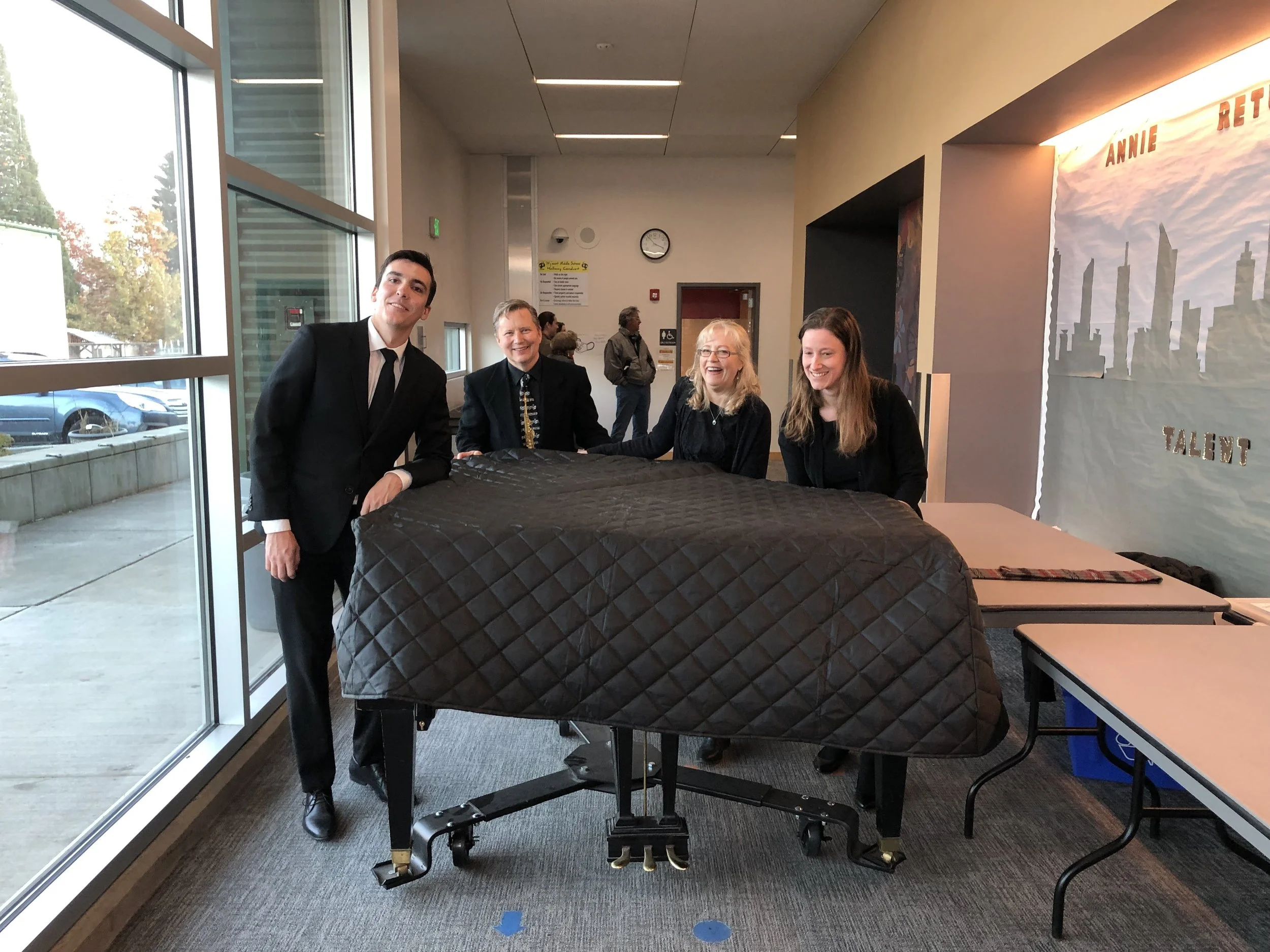 Mitchell Jett Spencer, Ken and Kathy Apland at Wy'east Performing Arts Center (PAC), standing by a piano