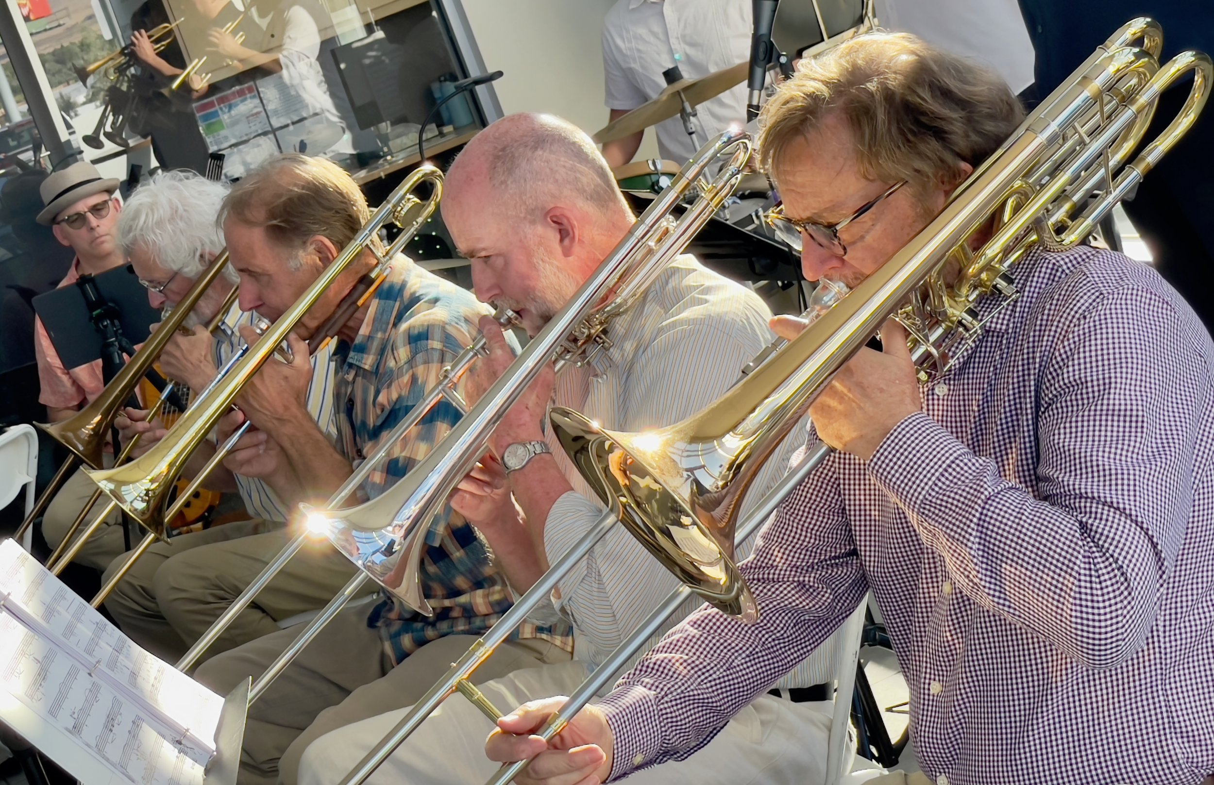 Ed Price playing the trombone with other Jazz Collective musicians at a concert at Columbia Gorge Toyota showroom