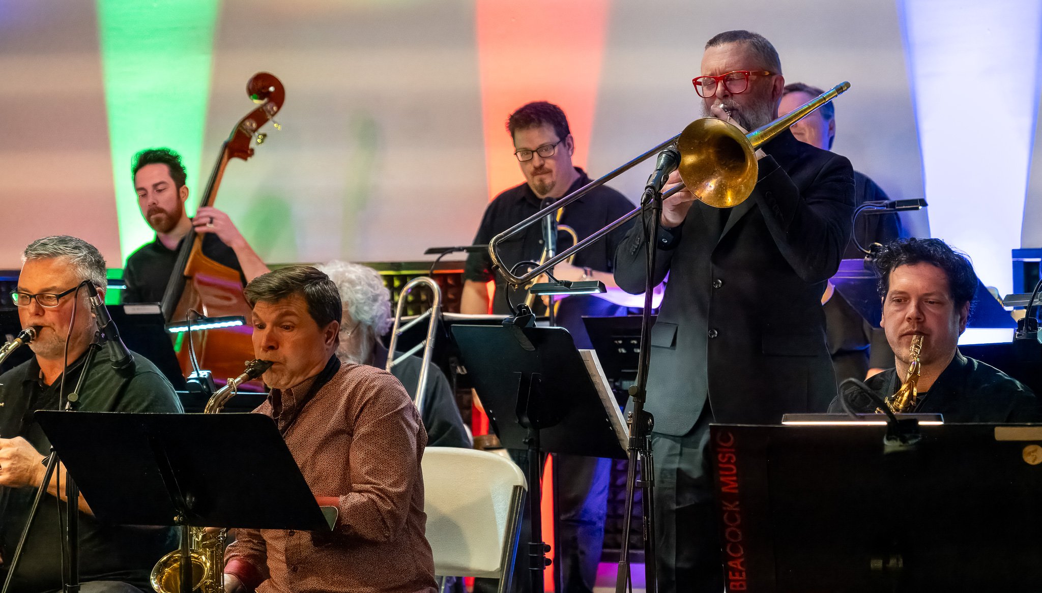 CGOA Jazz Collective Big Band musicians jamming at a concert at The Ruins, horns, drums and stand-up bass