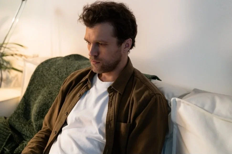 Man sitting thoughtfully, reflecting on his relationship patterns