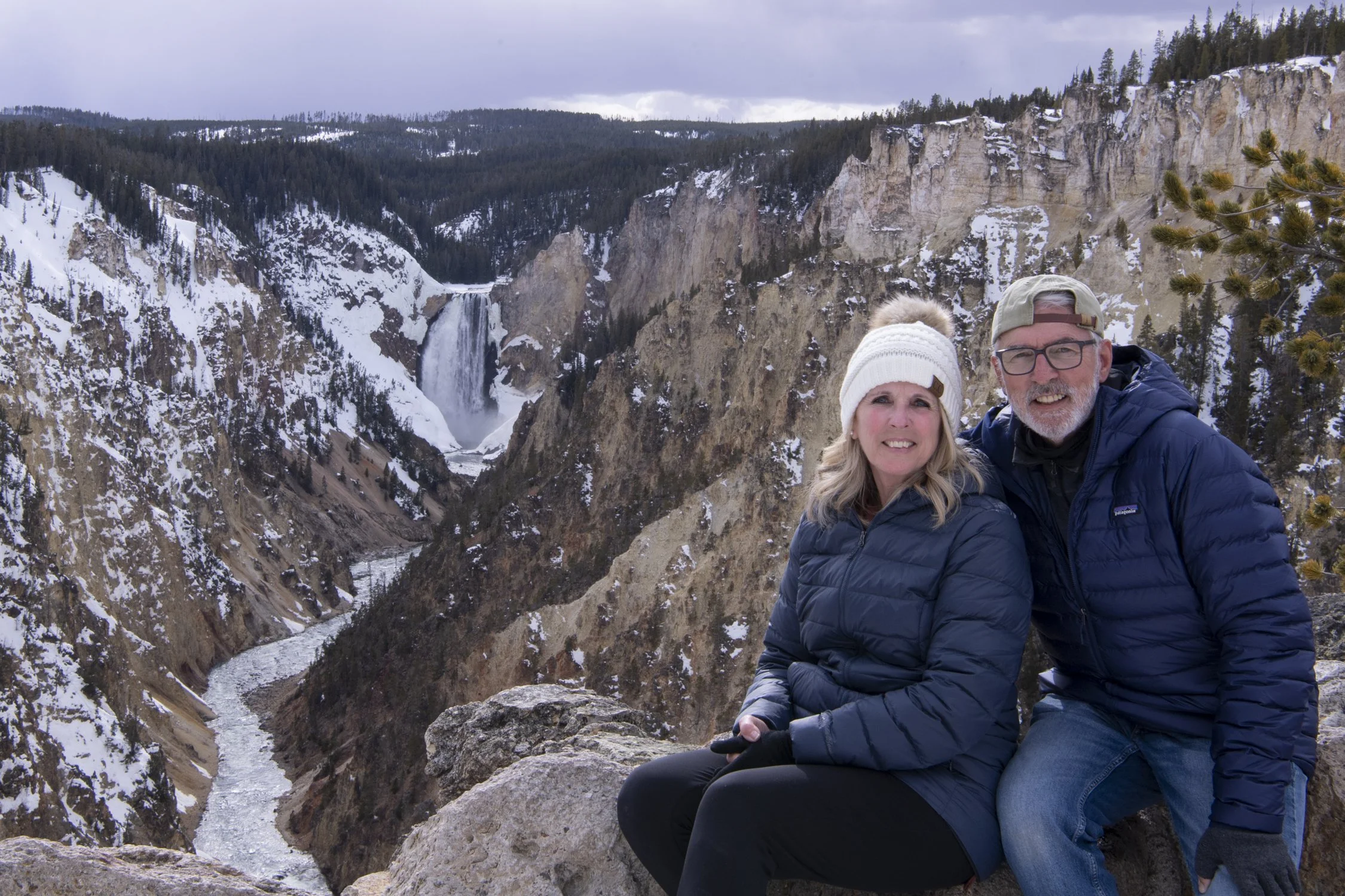 A photo of Stan and Julie Dunlap at a snowy artist point in yellowstone in winter