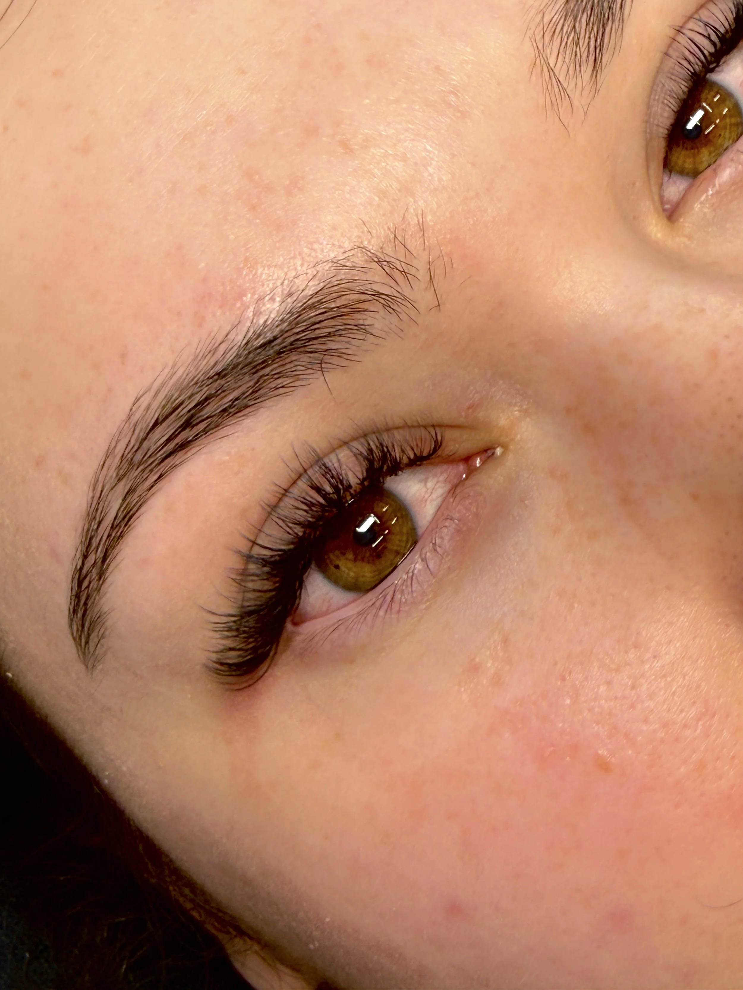 Custom volume lash extensions applied by a licensed esthetician at NYBGC in Kaysville, Utah for full, lightweight, long-lasting lashes.