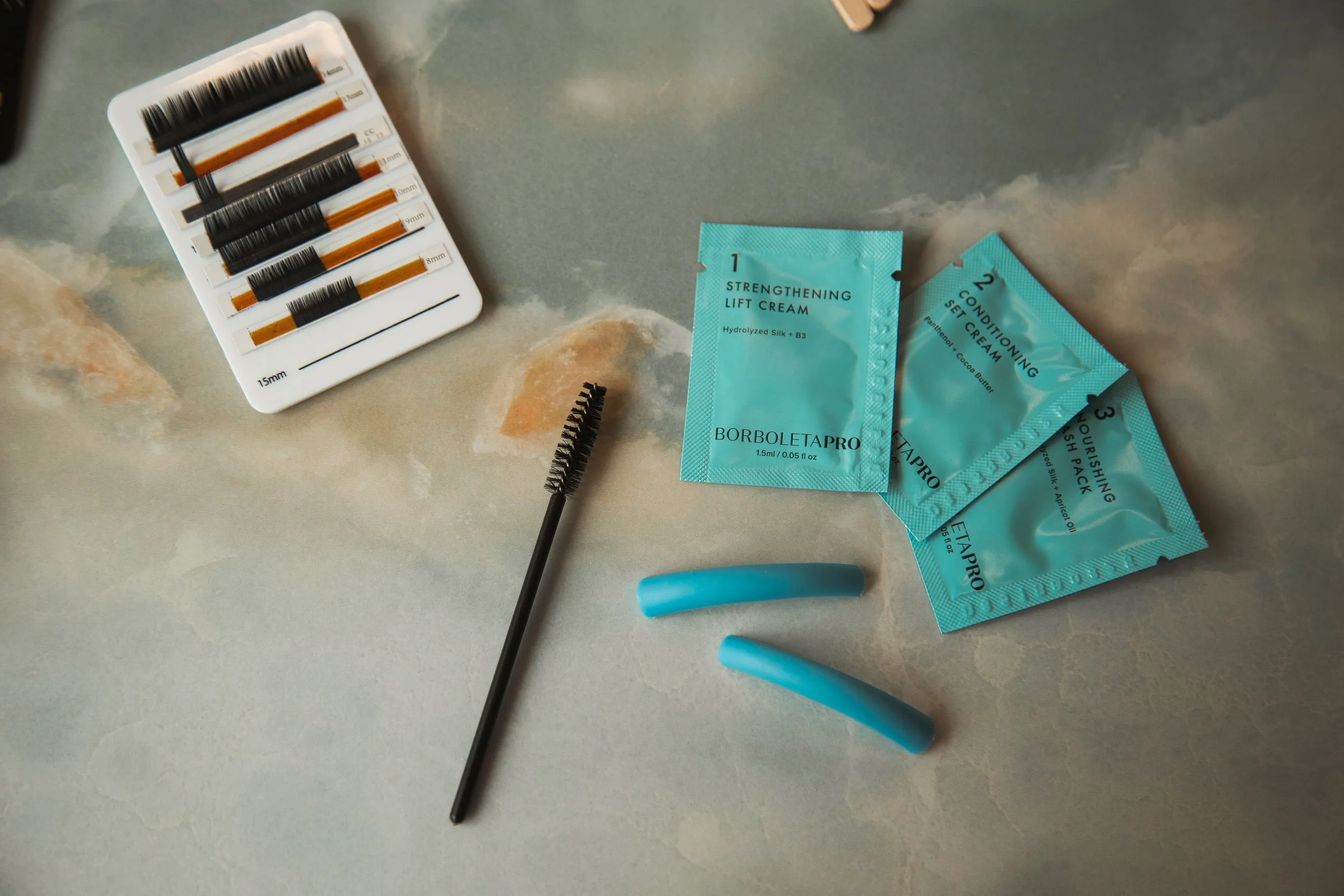 Professional brow lamination and lash lift products used during brow and lash enhancement services at NYBGC.